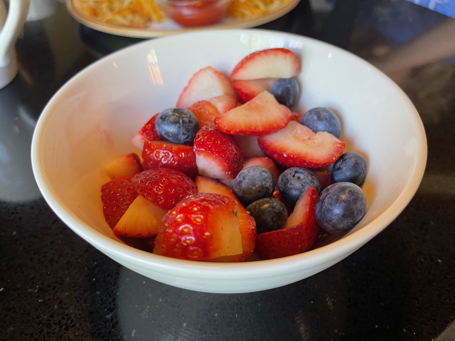 a bowl of fruit on a table