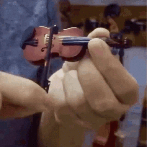 a person playing a miniature violin