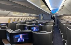 a row of seats with televisions on the side