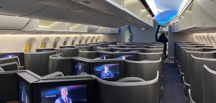 a row of seats with televisions on the side
