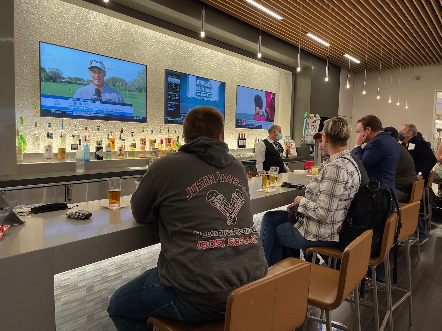 a group of people sitting at a bar