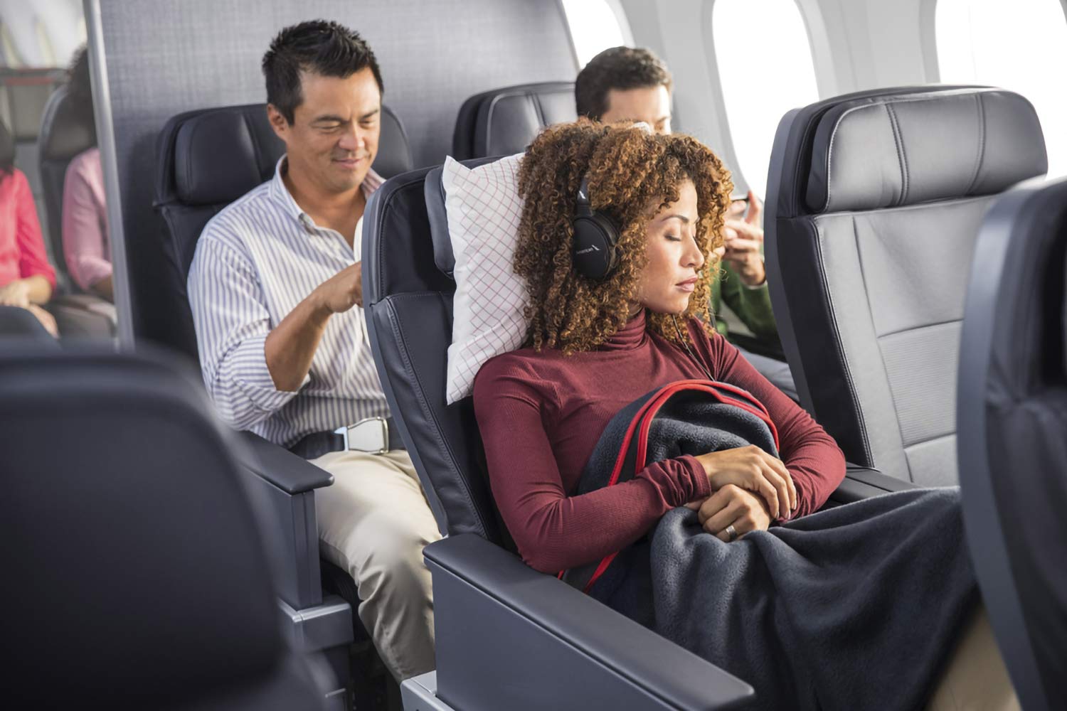 a woman sleeping in an airplane