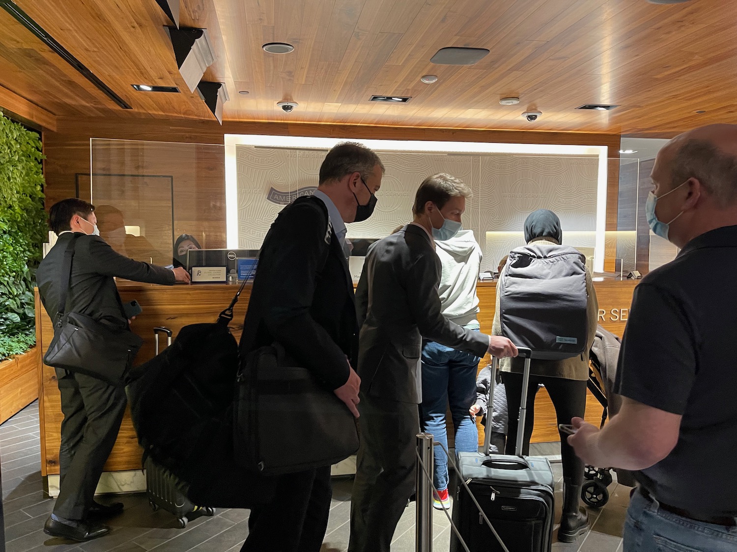 a group of people with luggage in a hotel