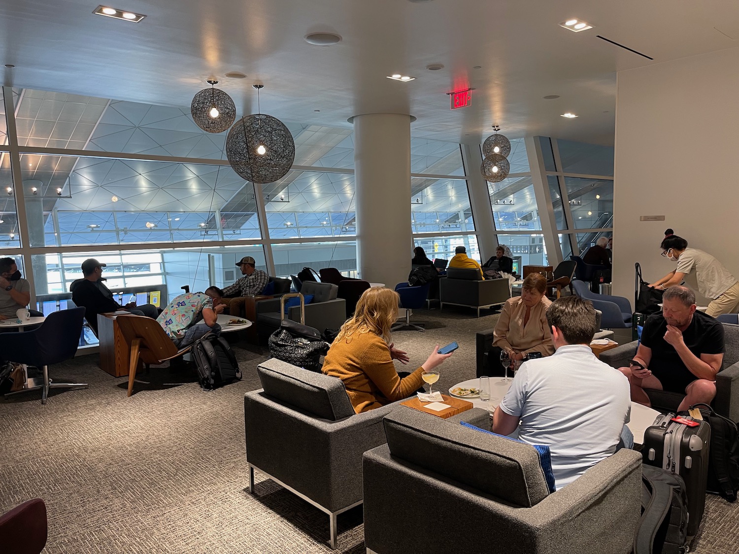 a group of people sitting in chairs in a lounge area