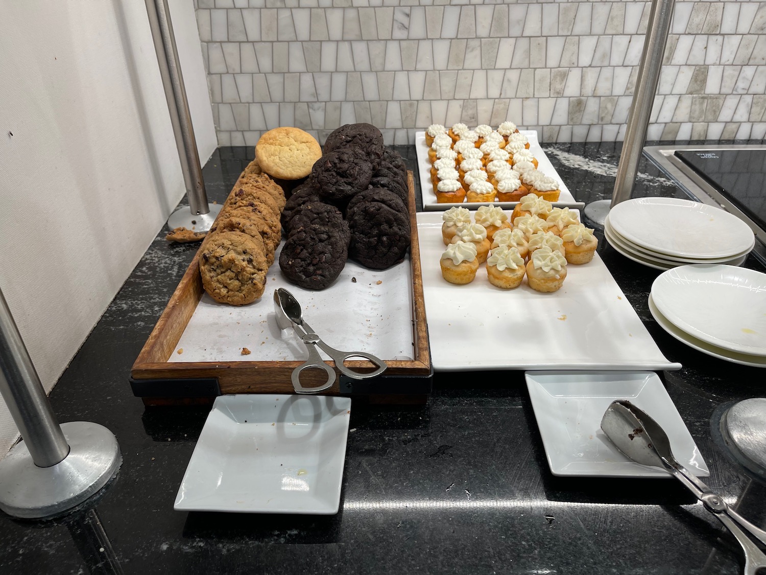 a tray of cookies and cupcakes