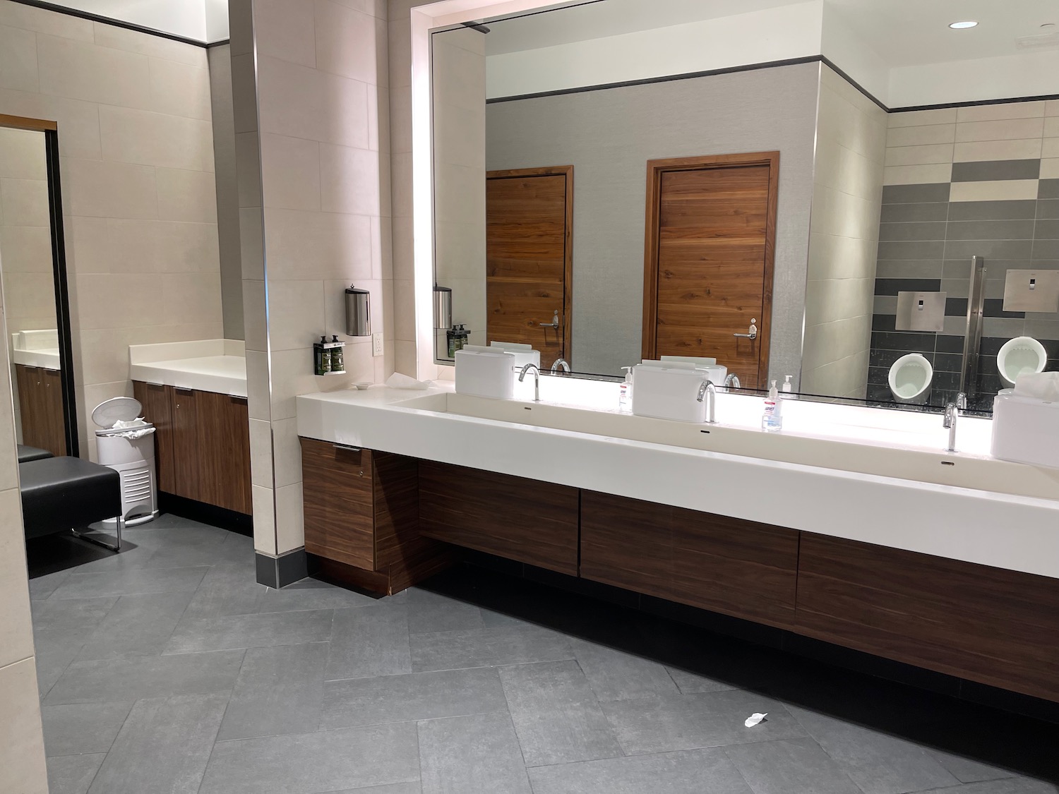 a bathroom with a large mirror and sinks