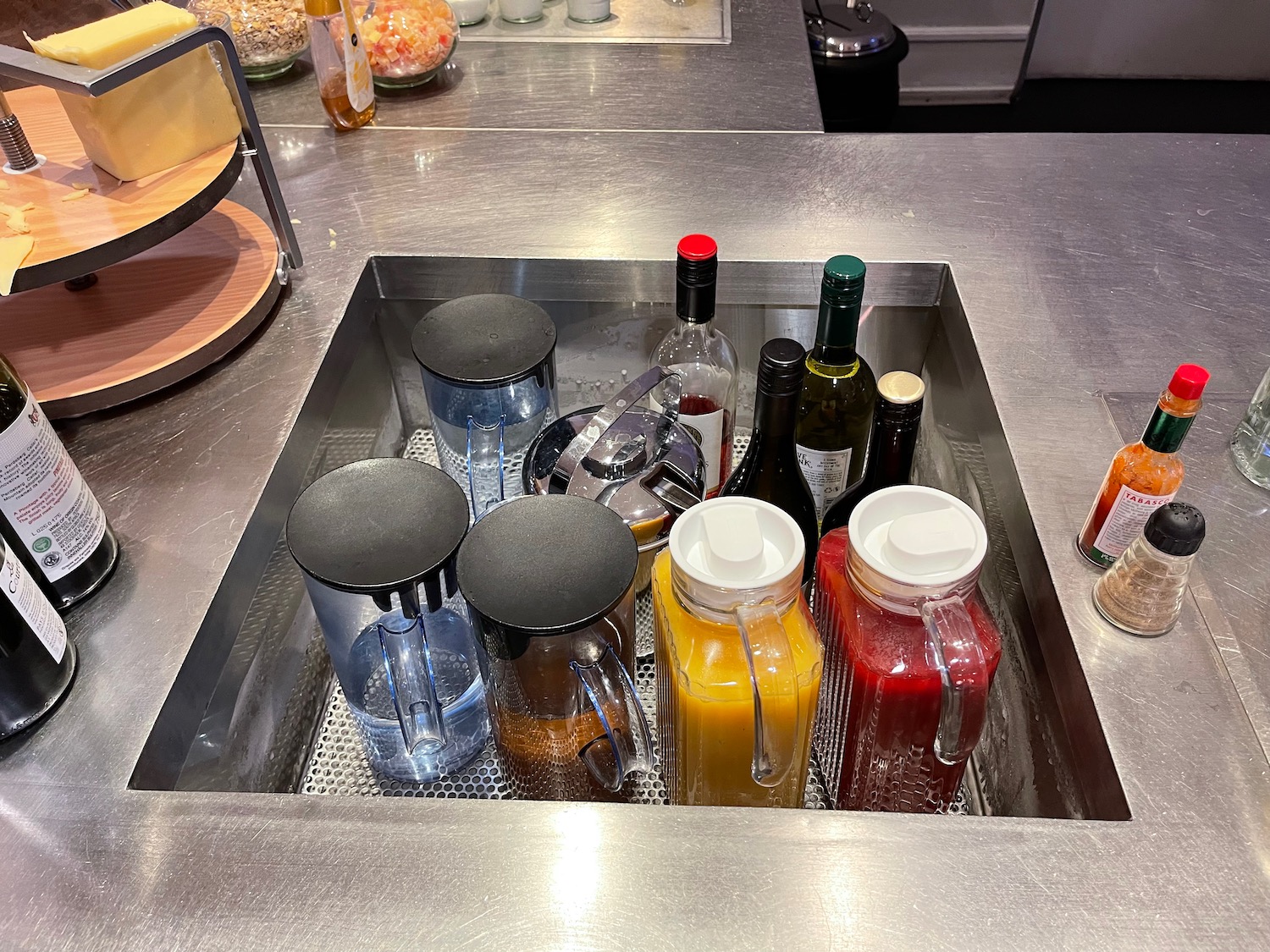 a sink with bottles of liquid and juice