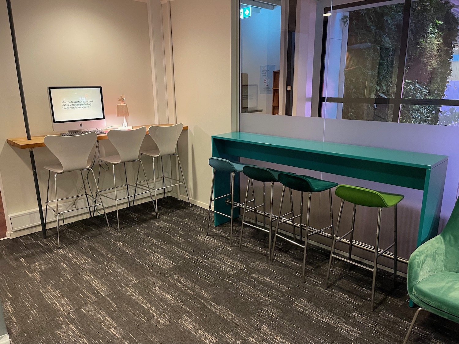 a room with a desk and stools