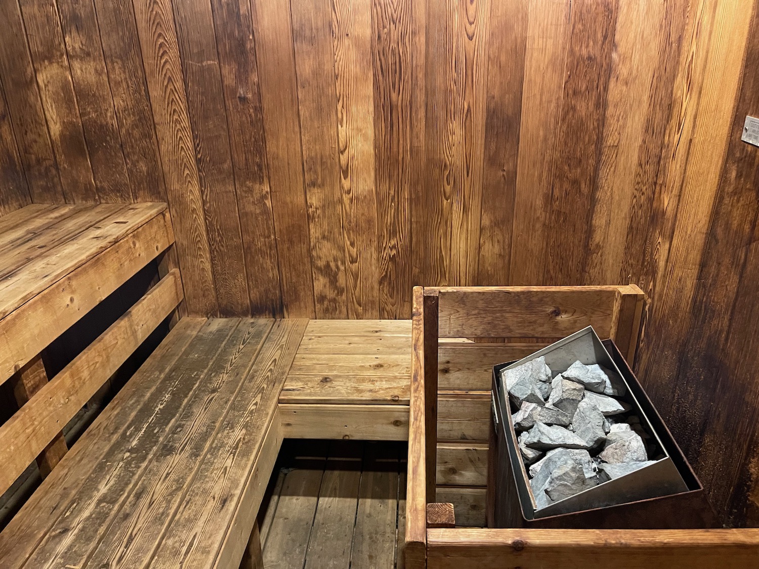 a wooden bench with a bucket of rocks in it