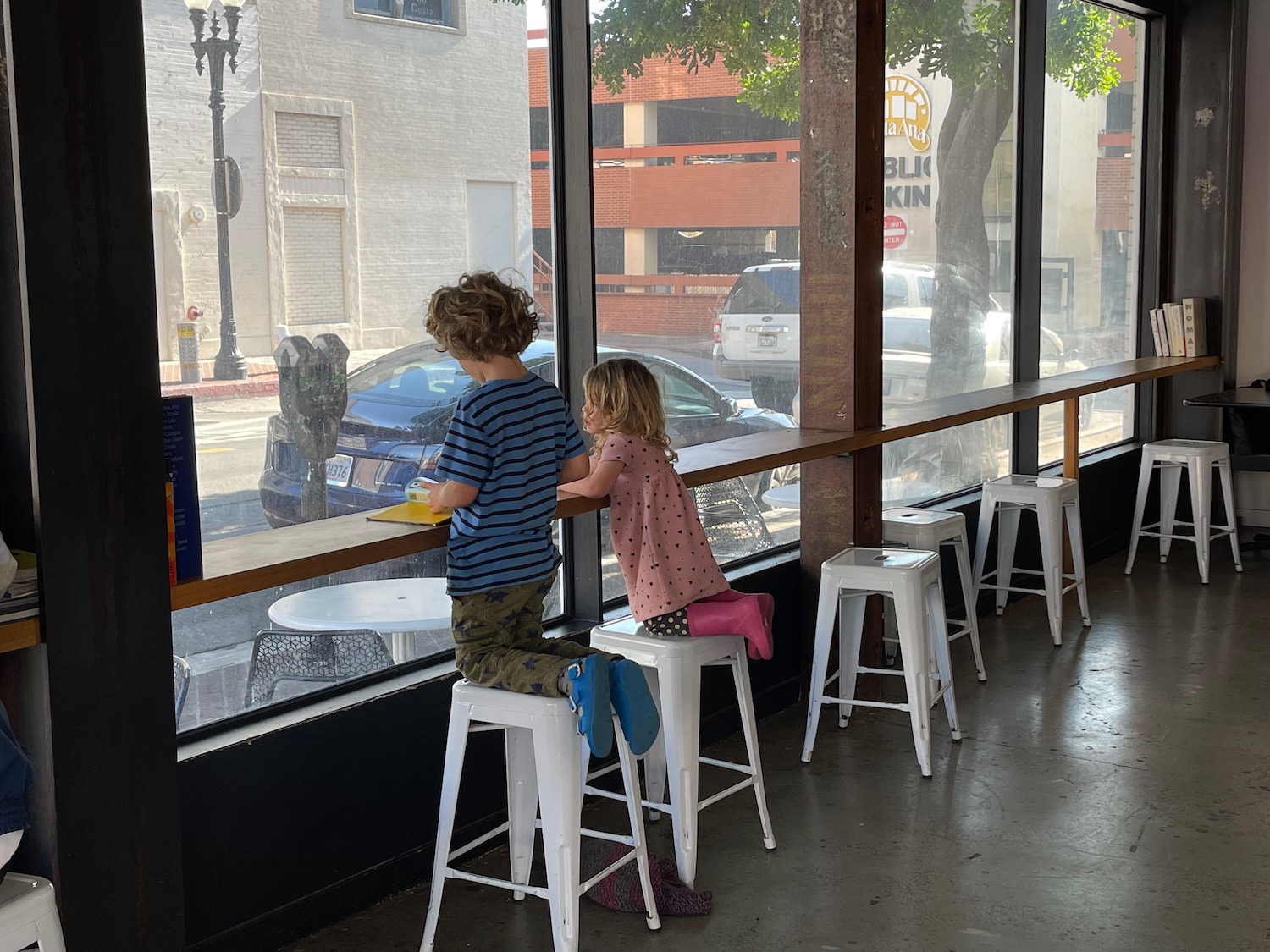 a two children sitting at a window