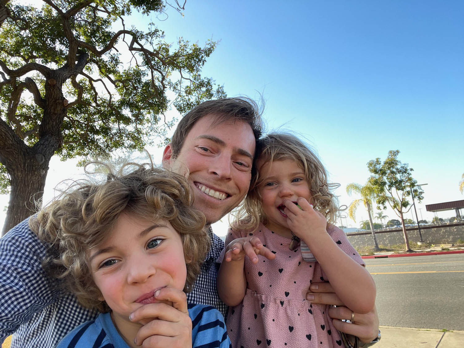 a man and two children posing for a selfie
