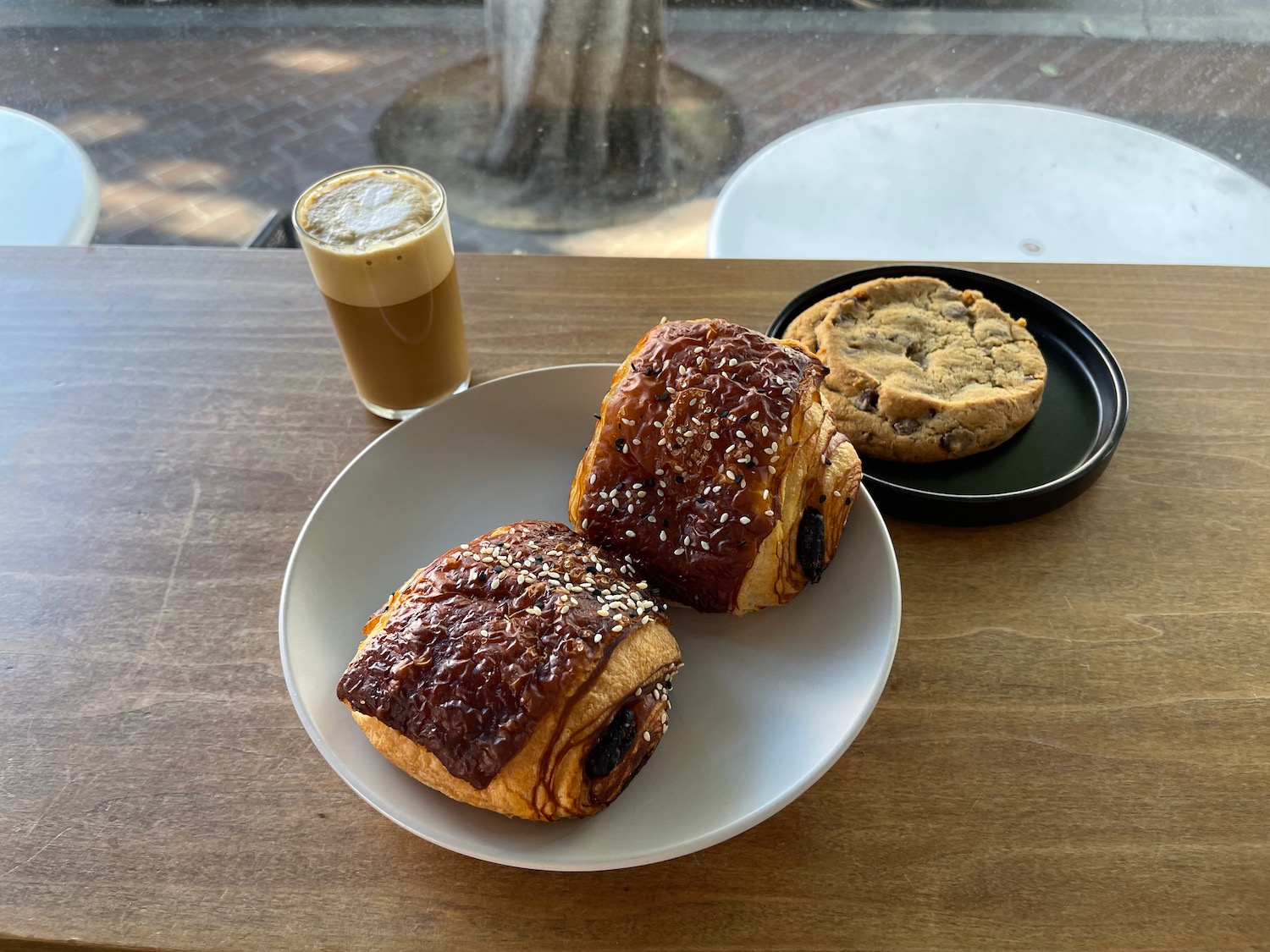 a plate of pastries and a glass of coffee