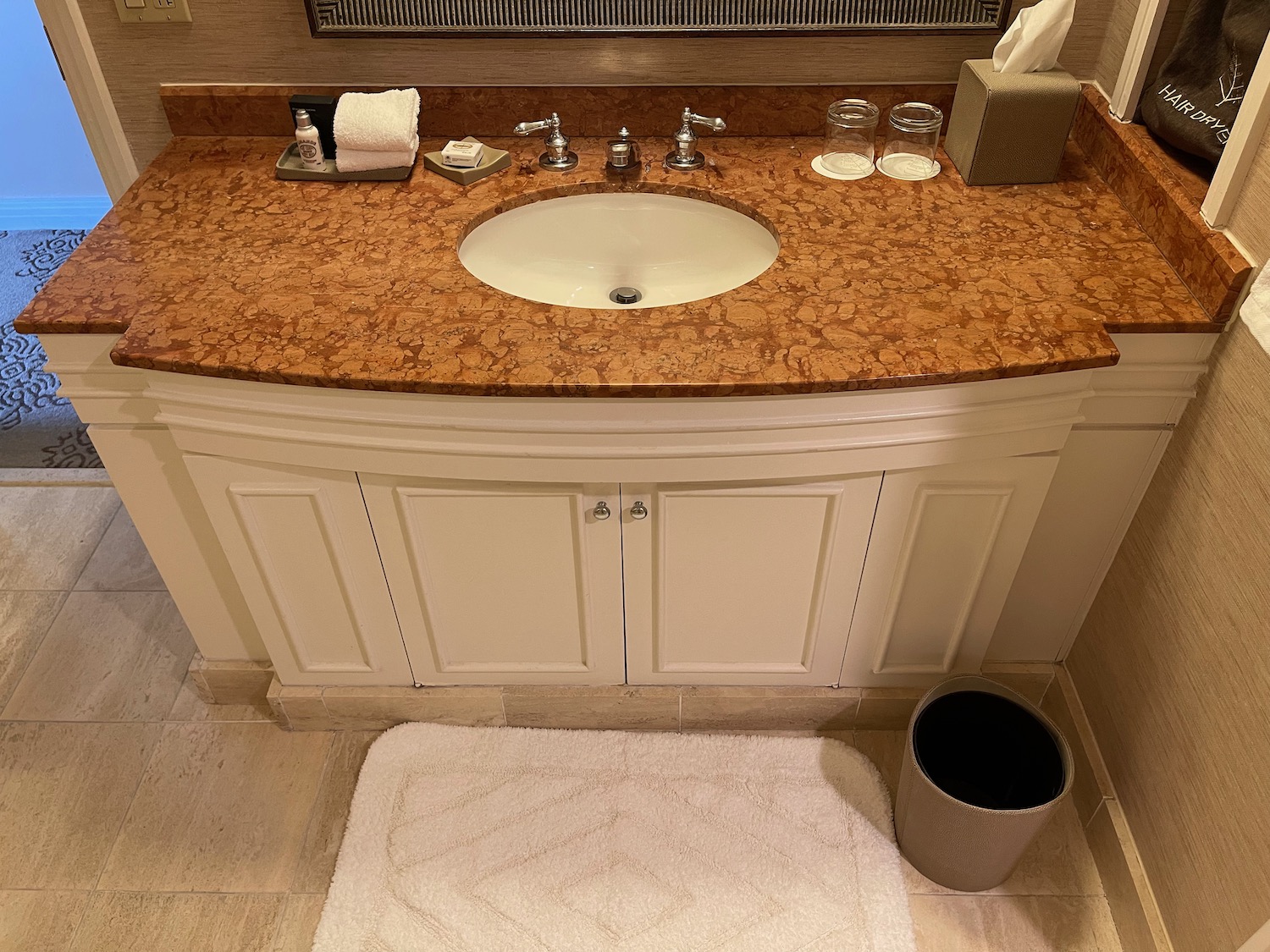 a bathroom sink with a white rug