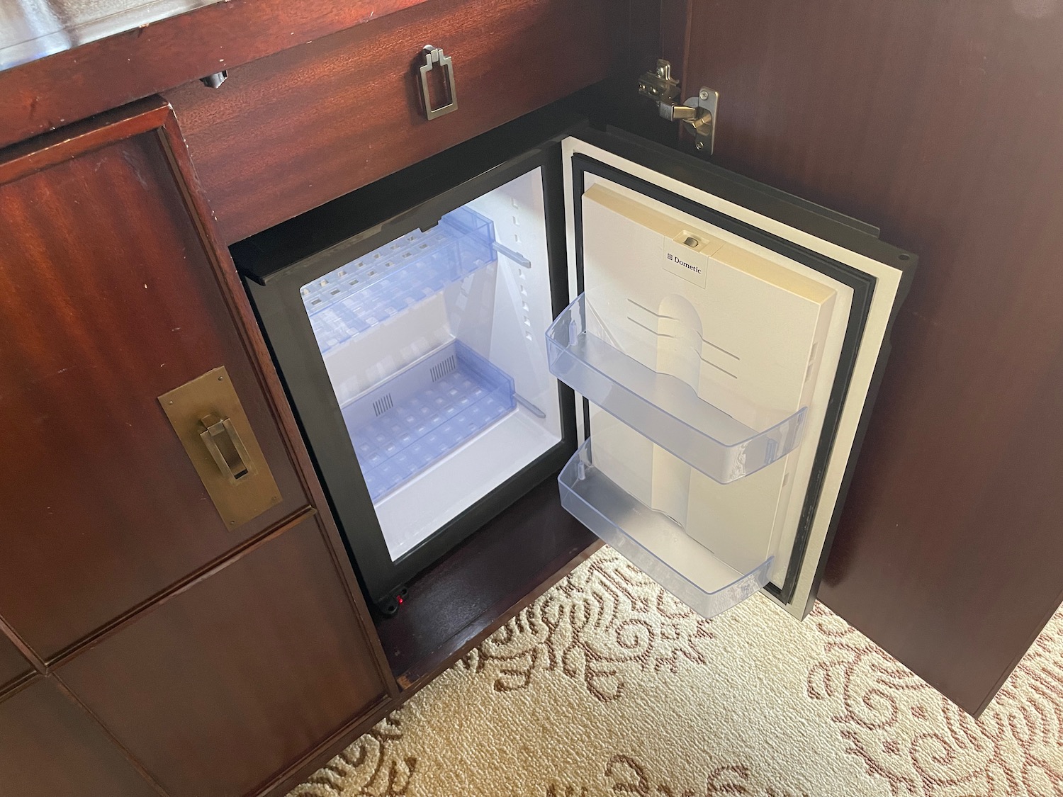 a small refrigerator in a cabinet