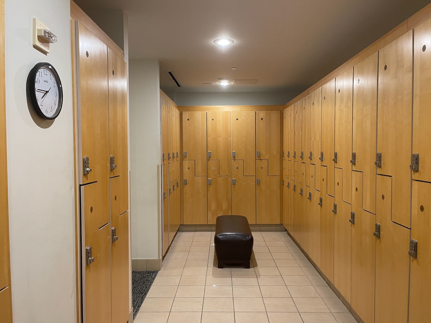 a locker room with a bench and many lockers