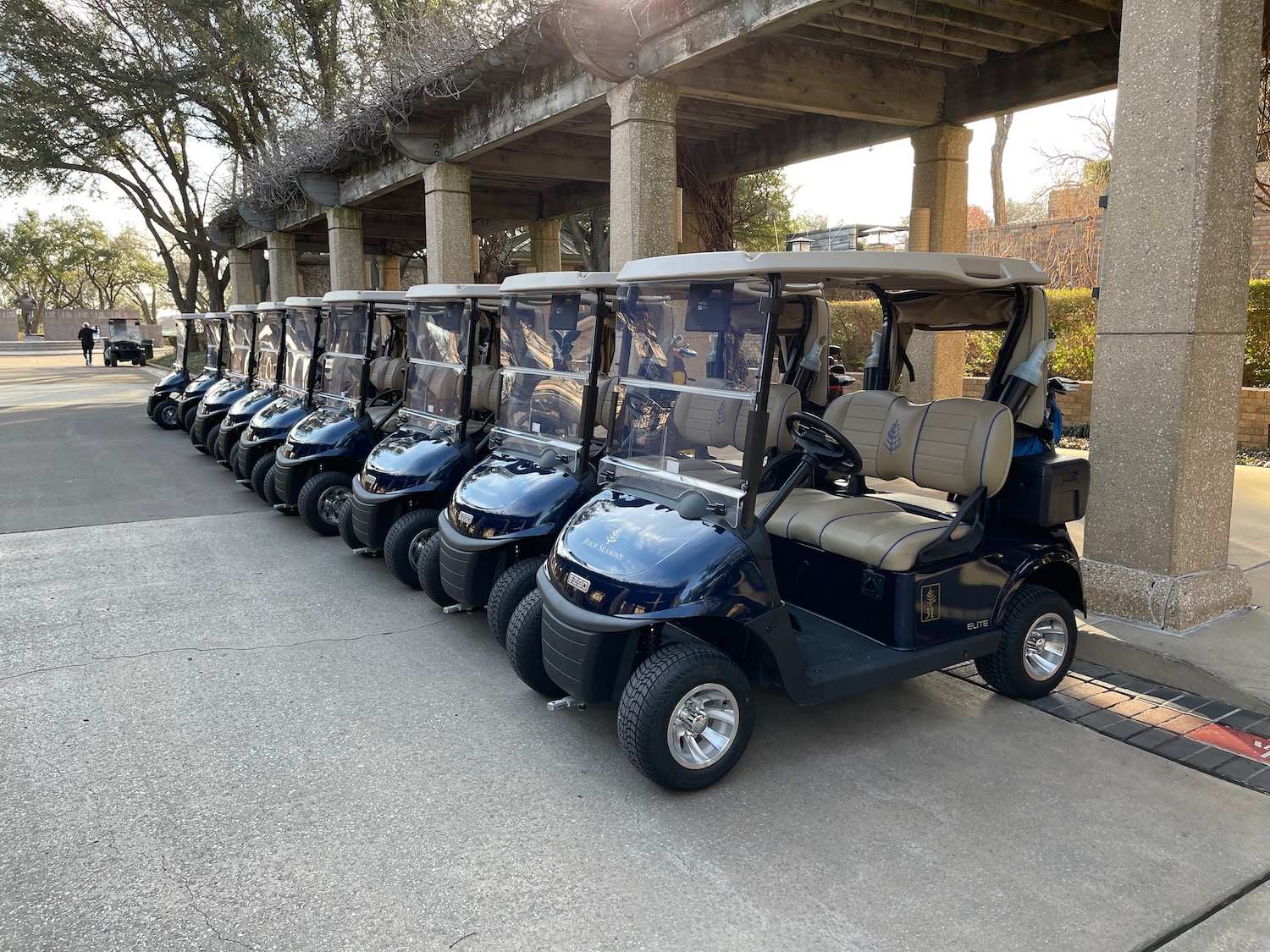 a row of golf carts parked in a line