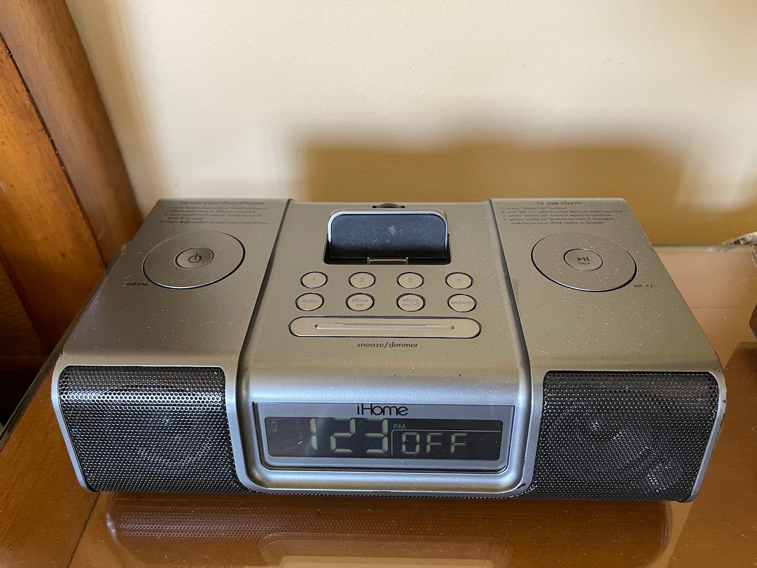 a silver radio with a clock and speakers