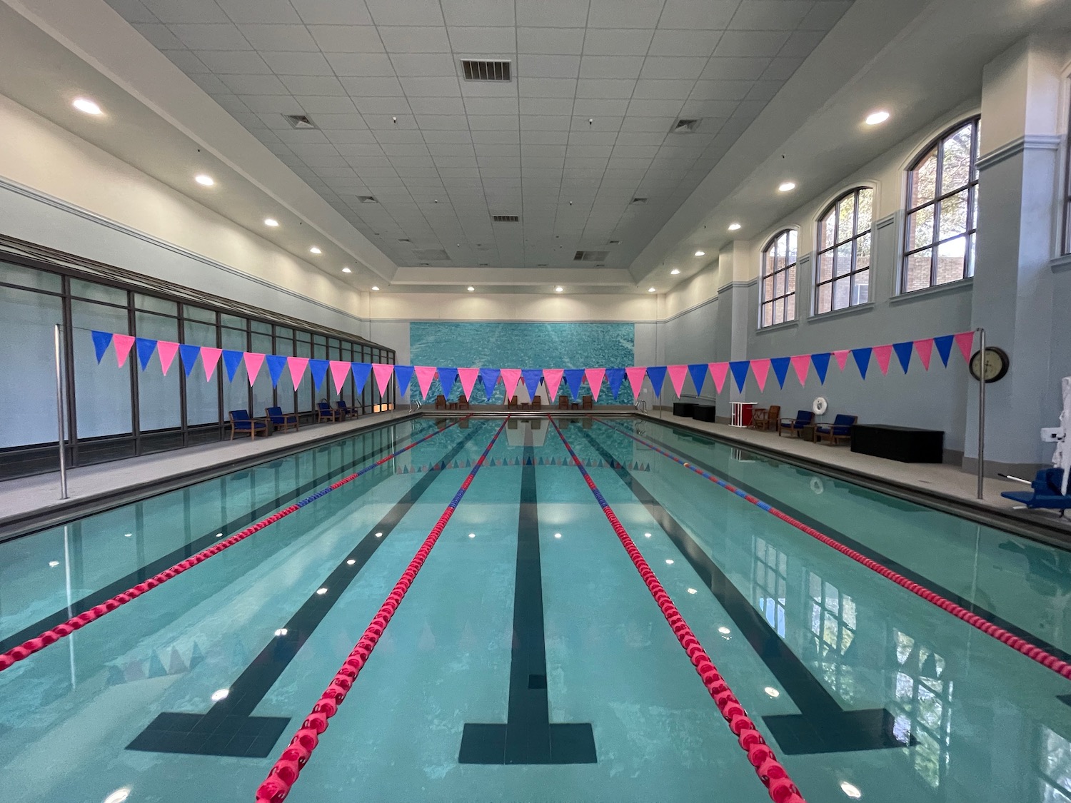 a swimming pool with flags in the background