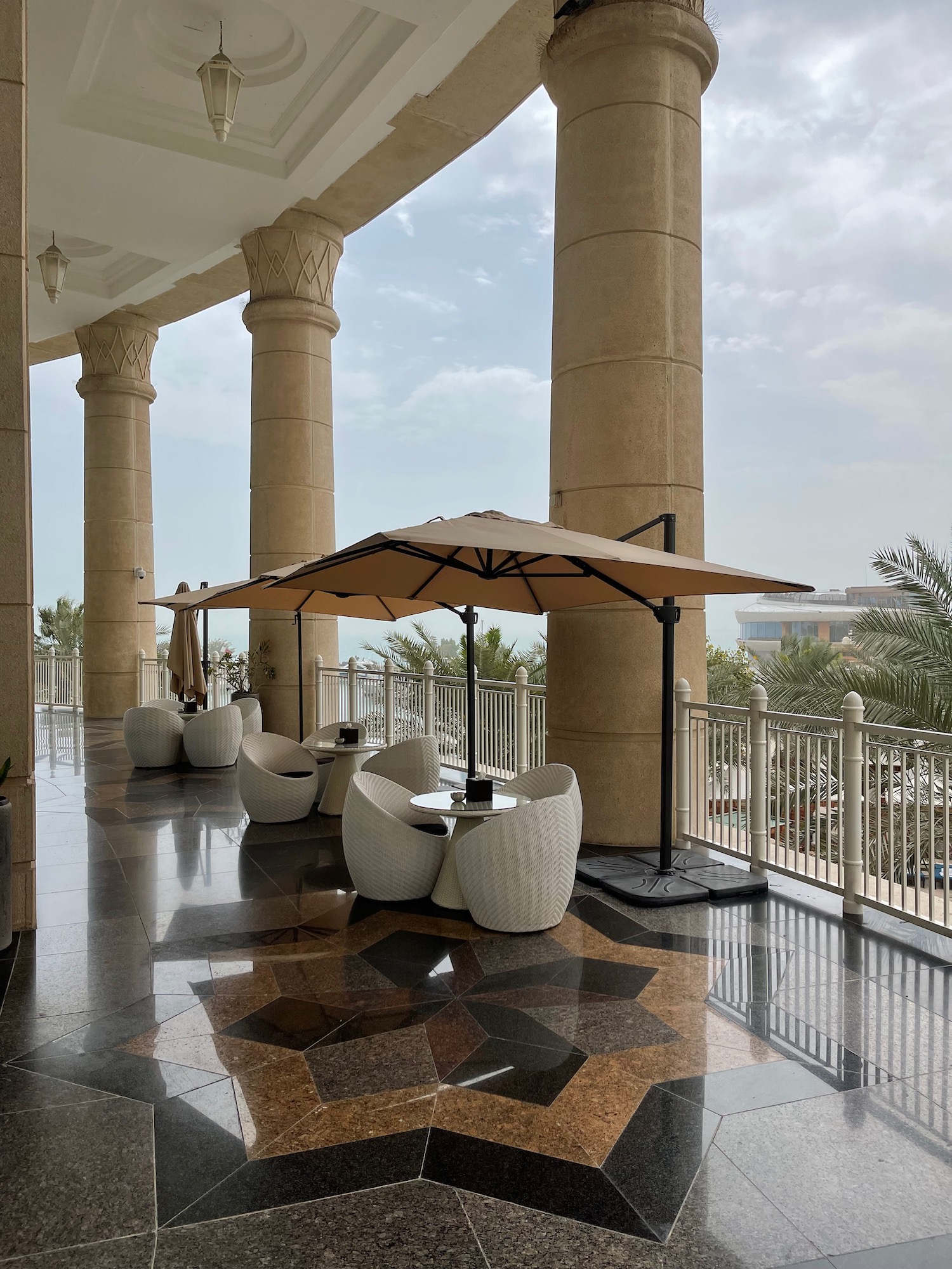 a patio with a table and umbrella