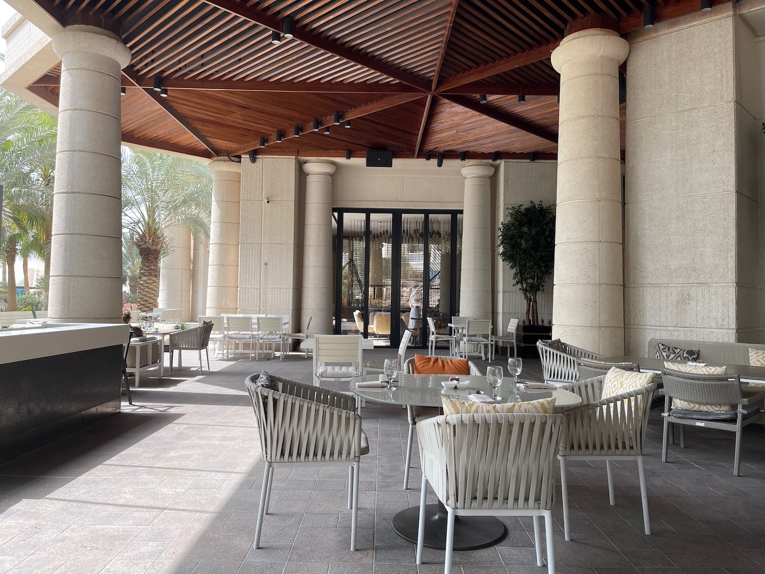 a patio with tables and chairs