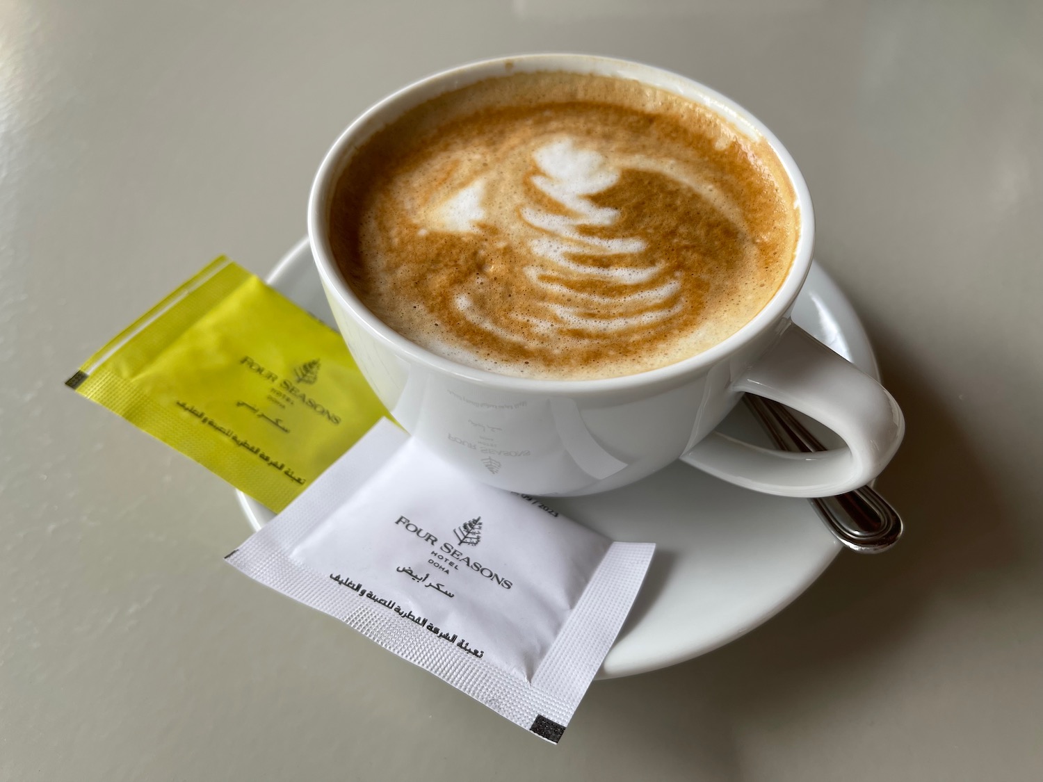 a cup of coffee with a design on the foam