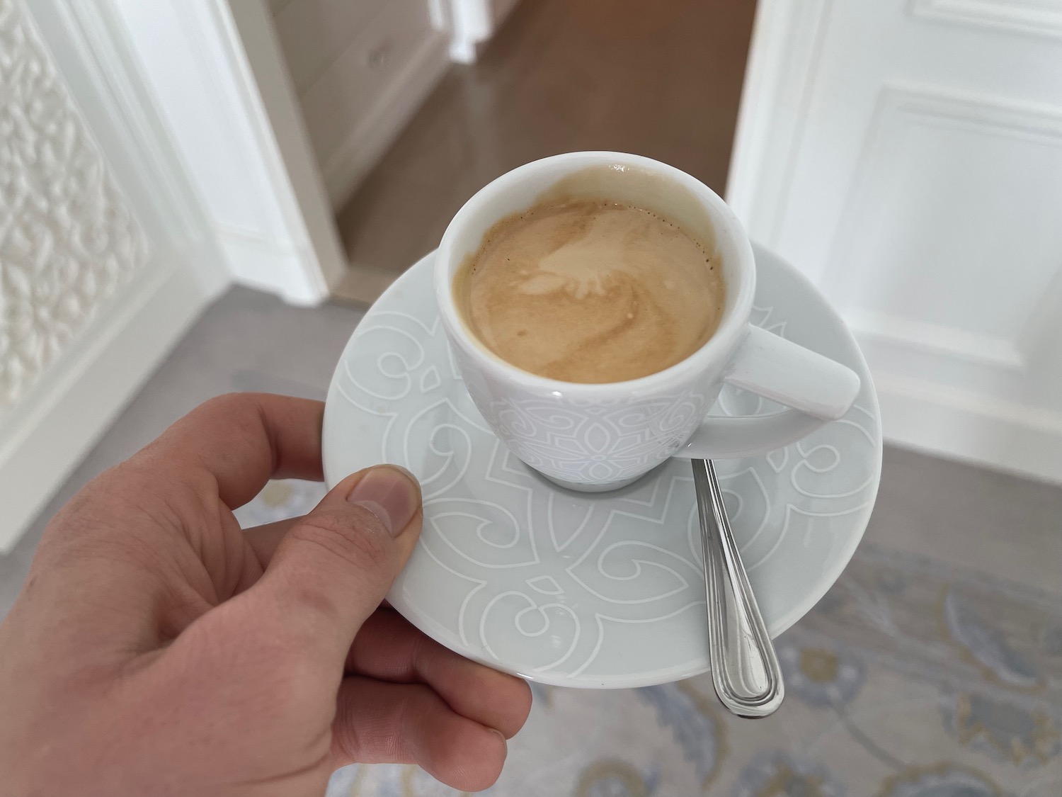 a hand holding a cup of coffee