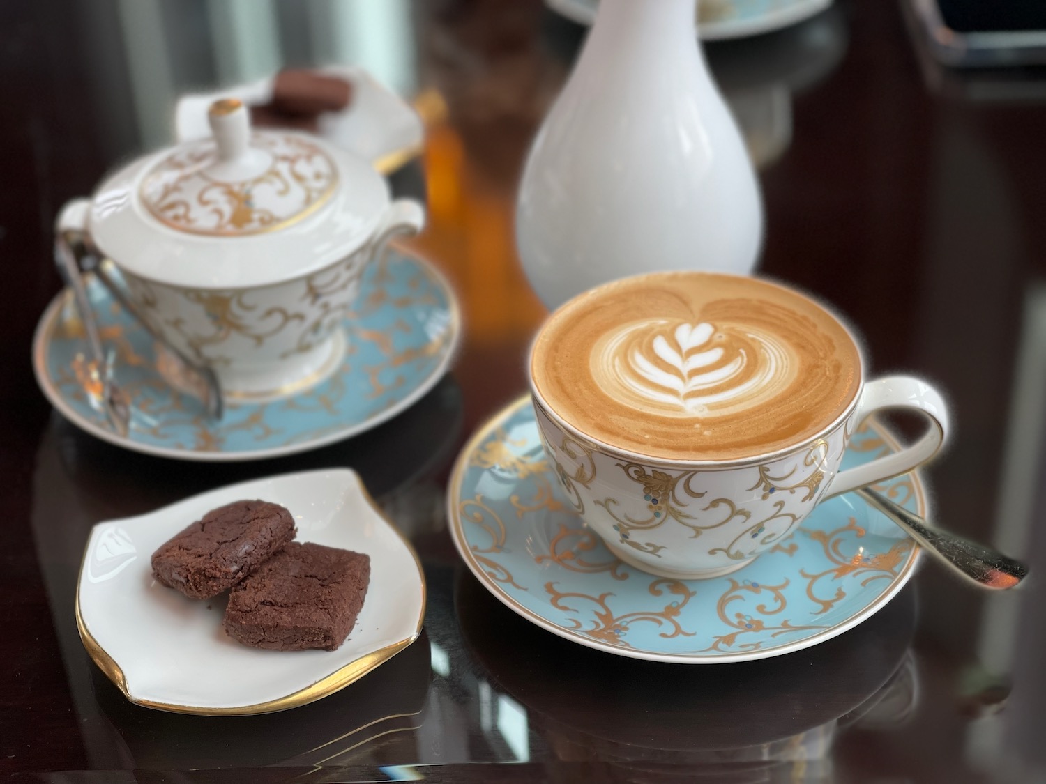 a cup of coffee and brownies on a table