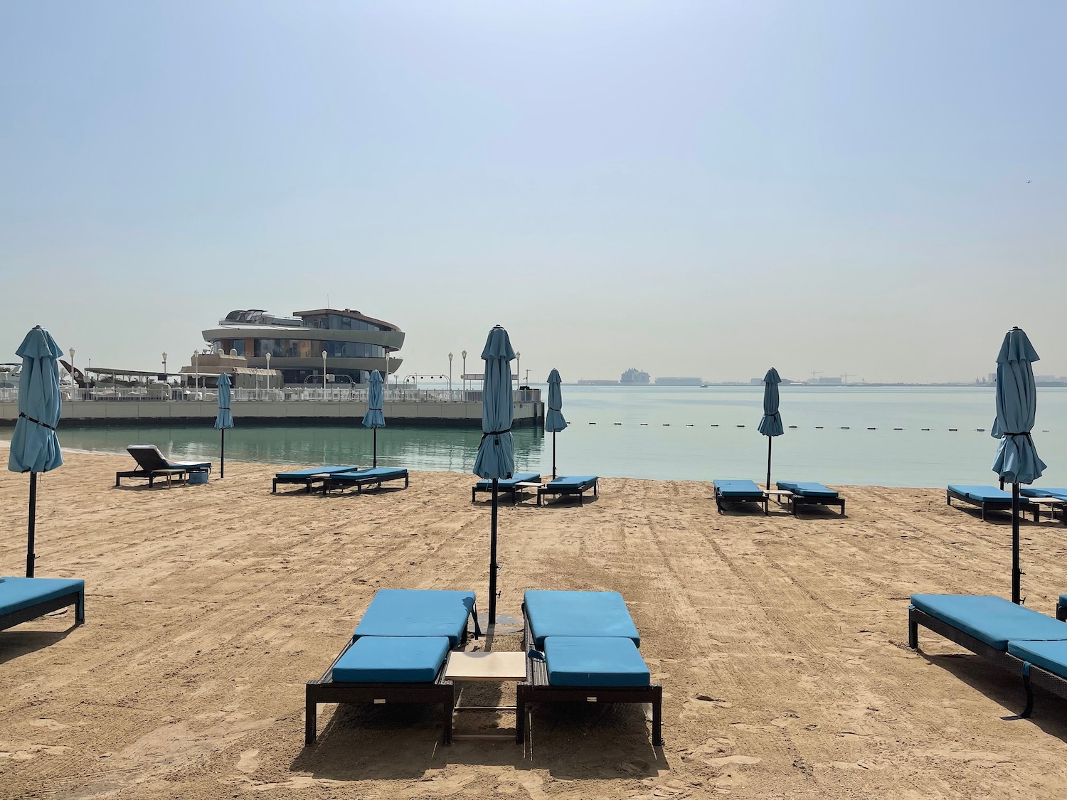 a group of lounge chairs on a beach