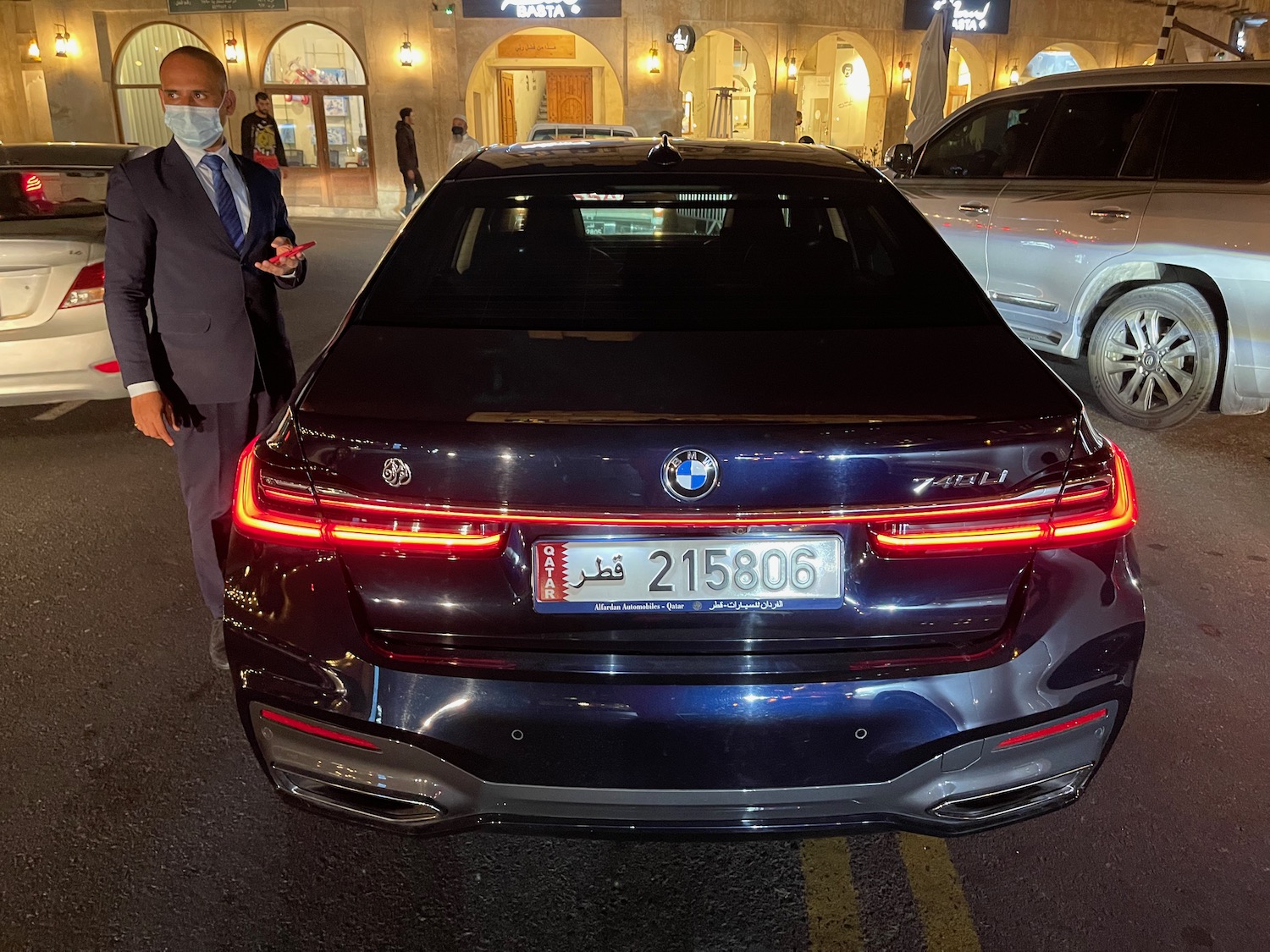 a man standing next to a car