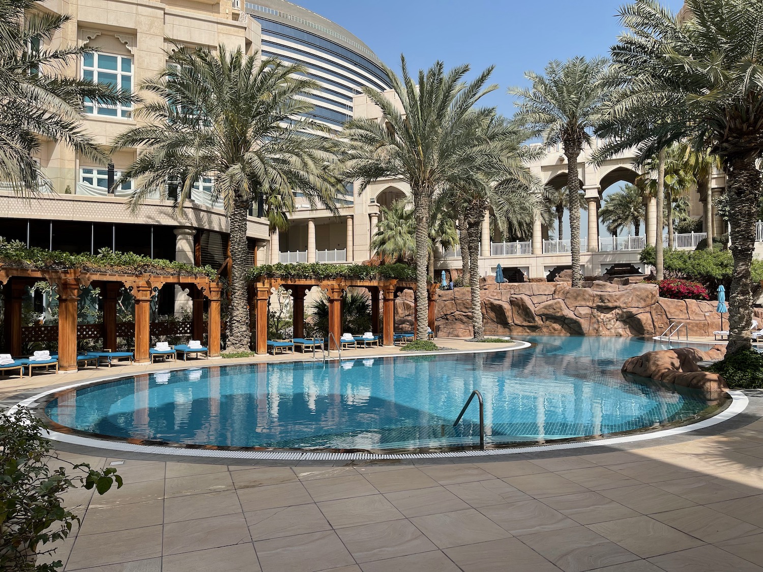 a pool with palm trees in the background