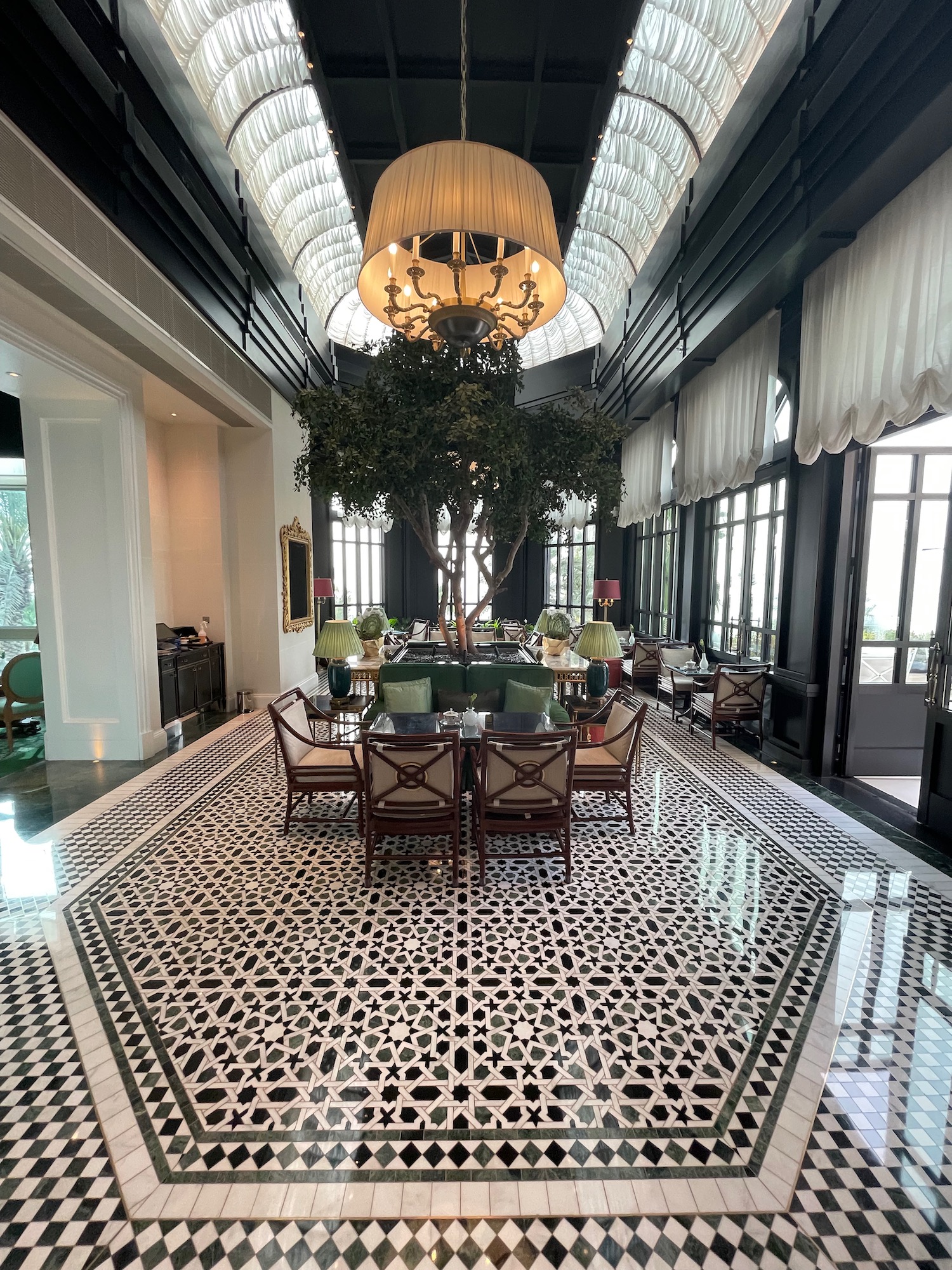 a room with a tree and chandelier