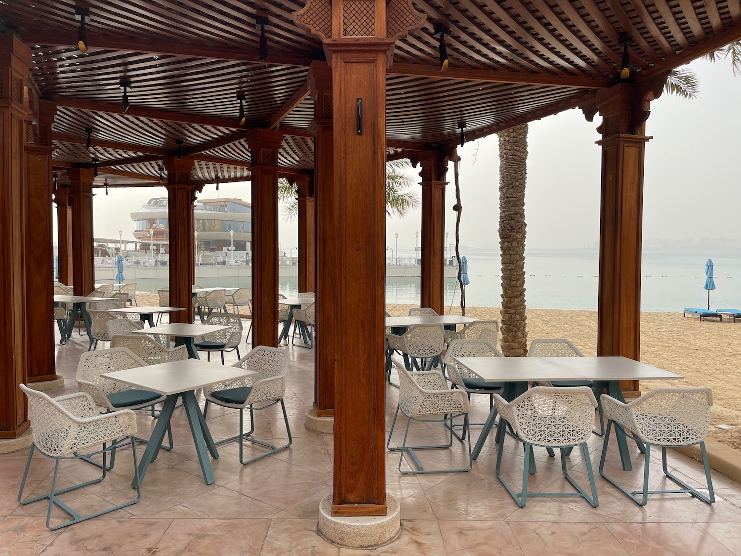 a covered patio with tables and chairs