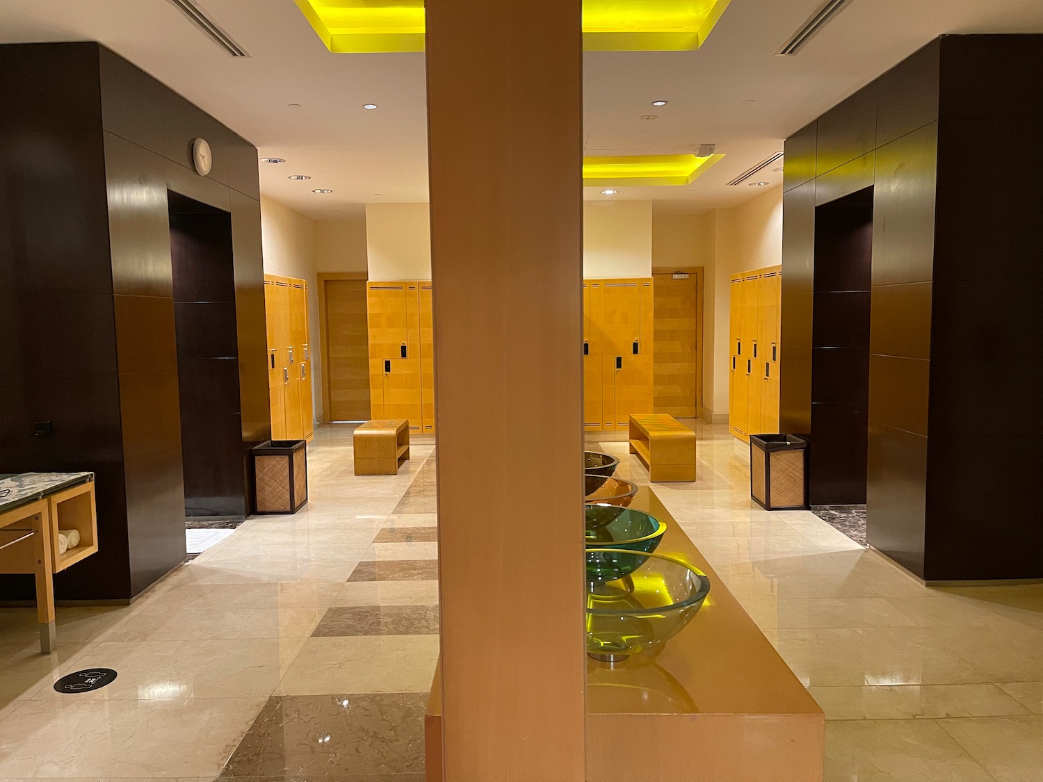 a hallway with a large pedestal and bowls on a table