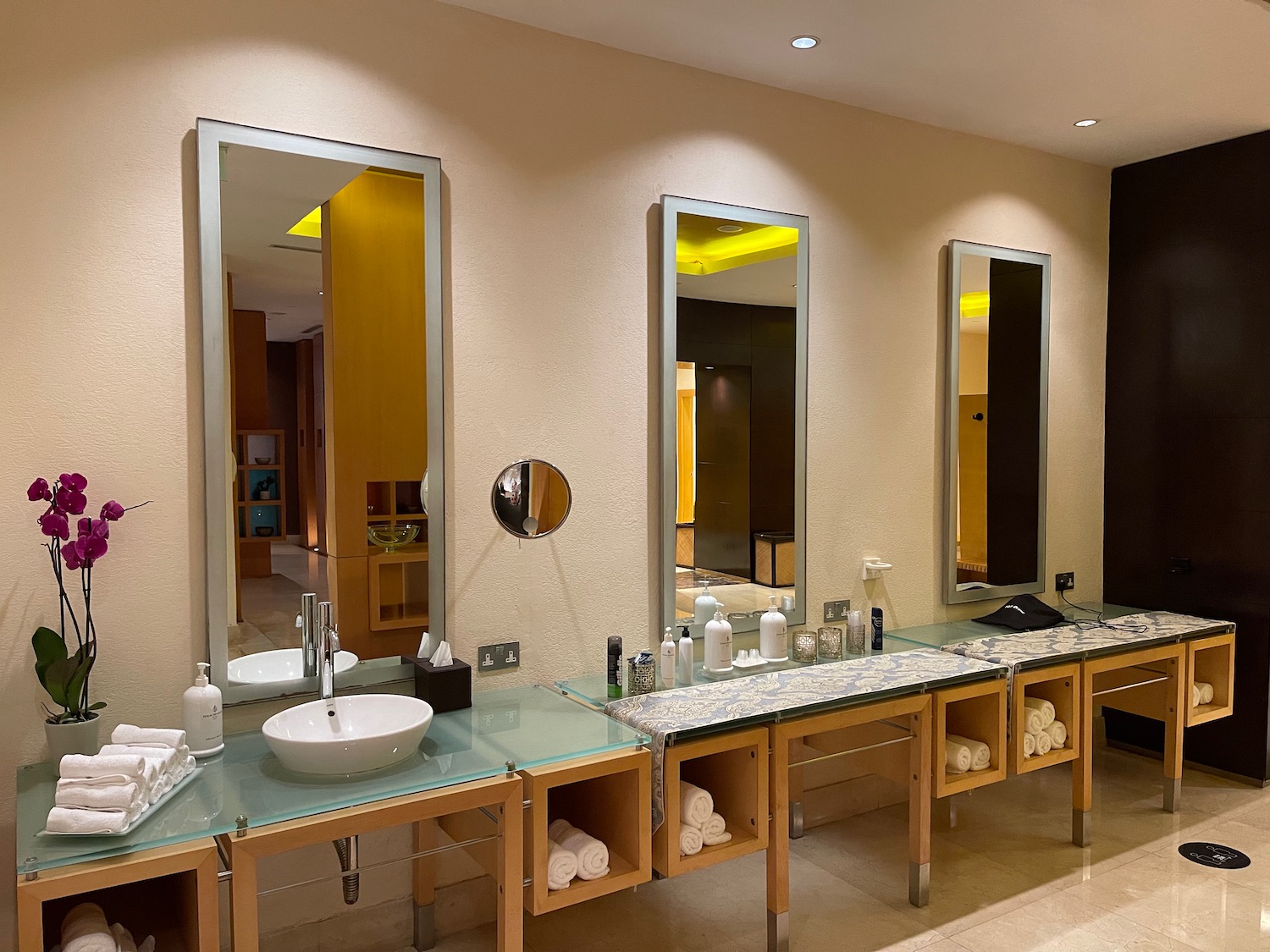 a bathroom with mirrors and sinks