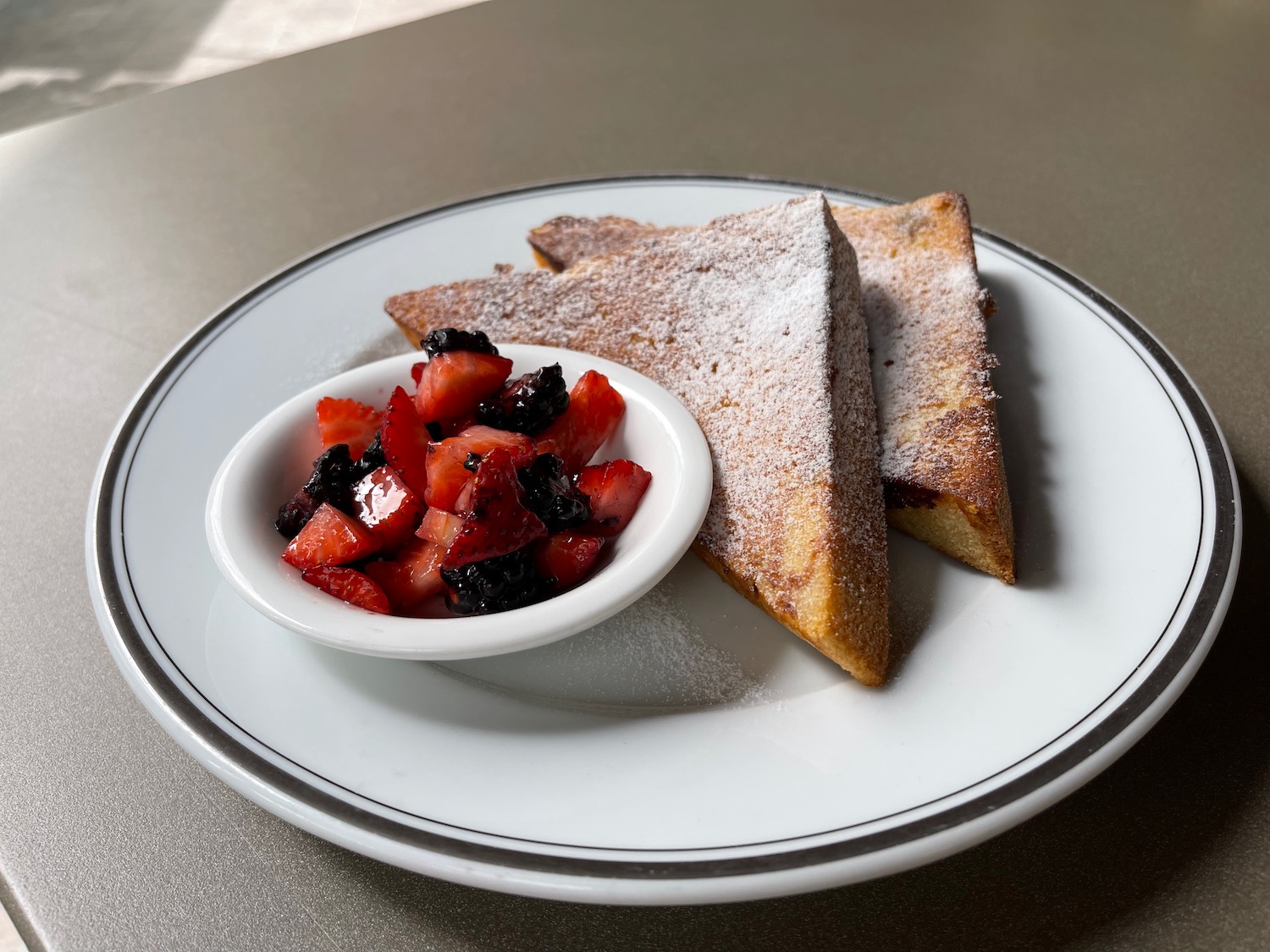 a plate of food with a bowl of fruit