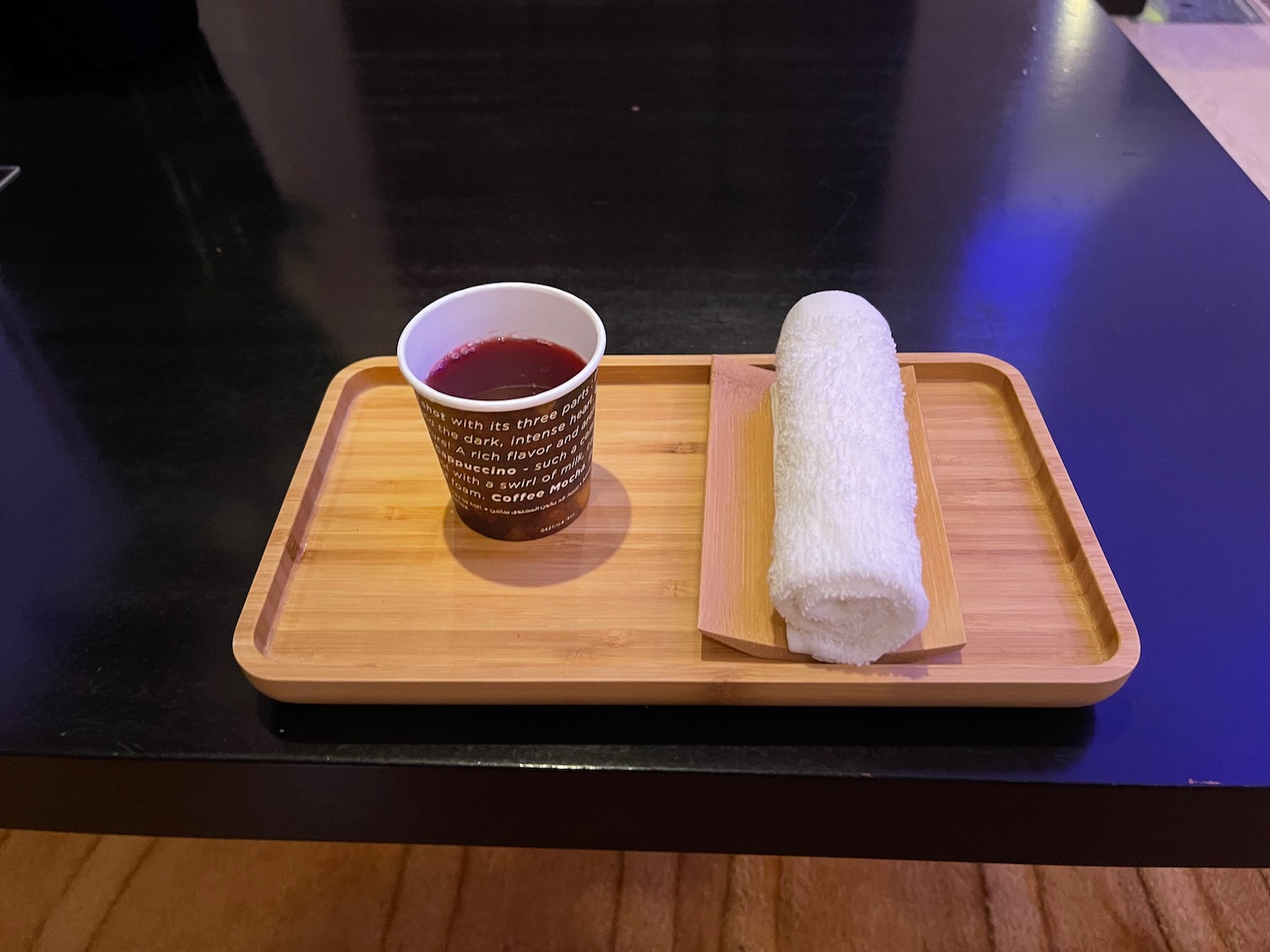 a tray with a cup of liquid and a cup of juice on it