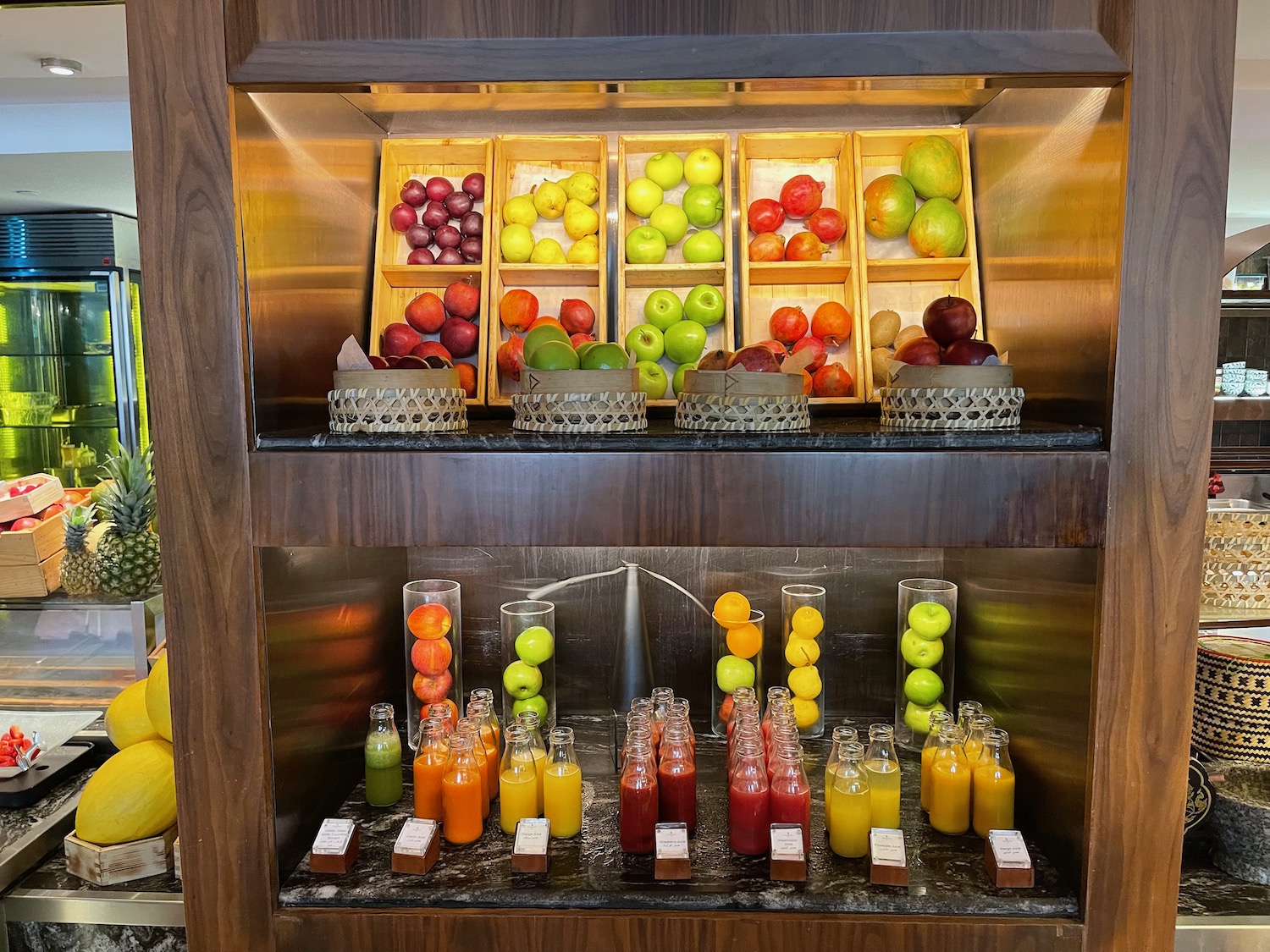 a shelf with fruit and juices