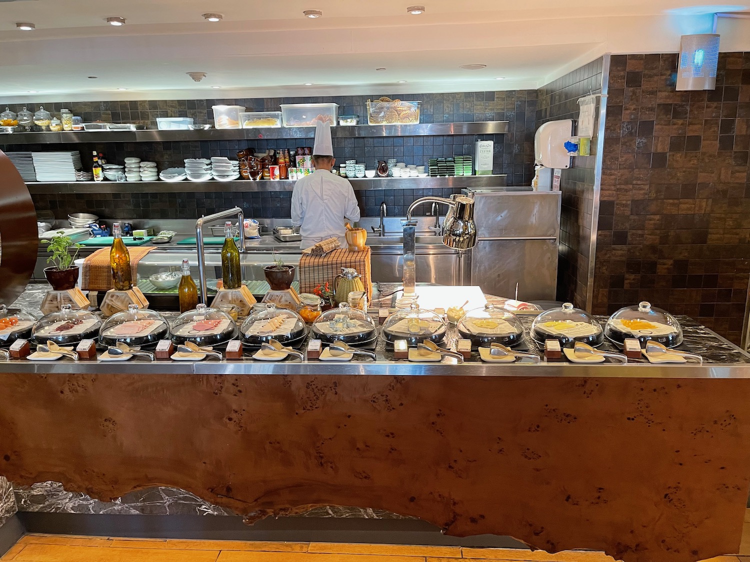 a chef standing behind a counter with food on it