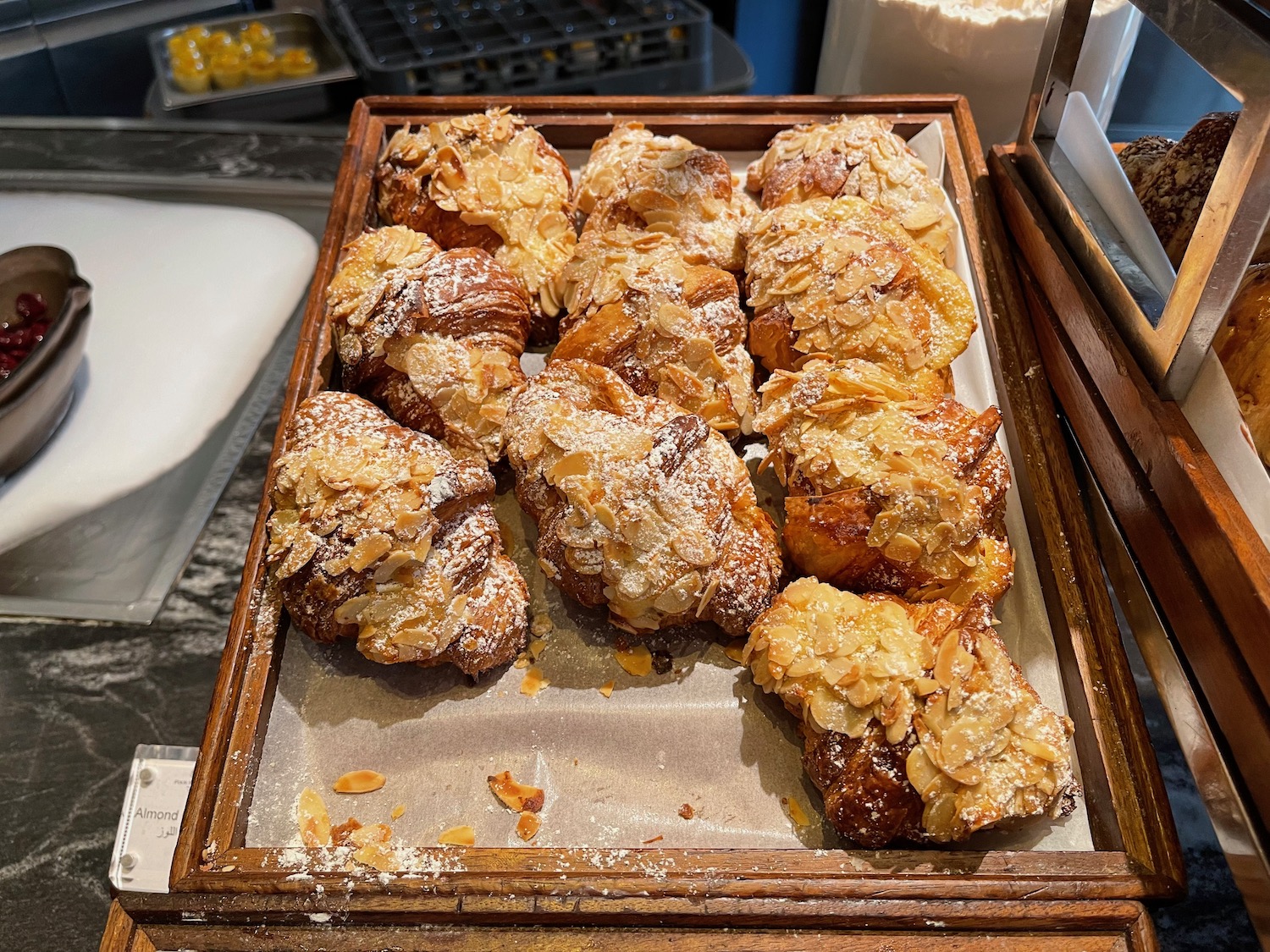 a tray of pastries with almond flakes