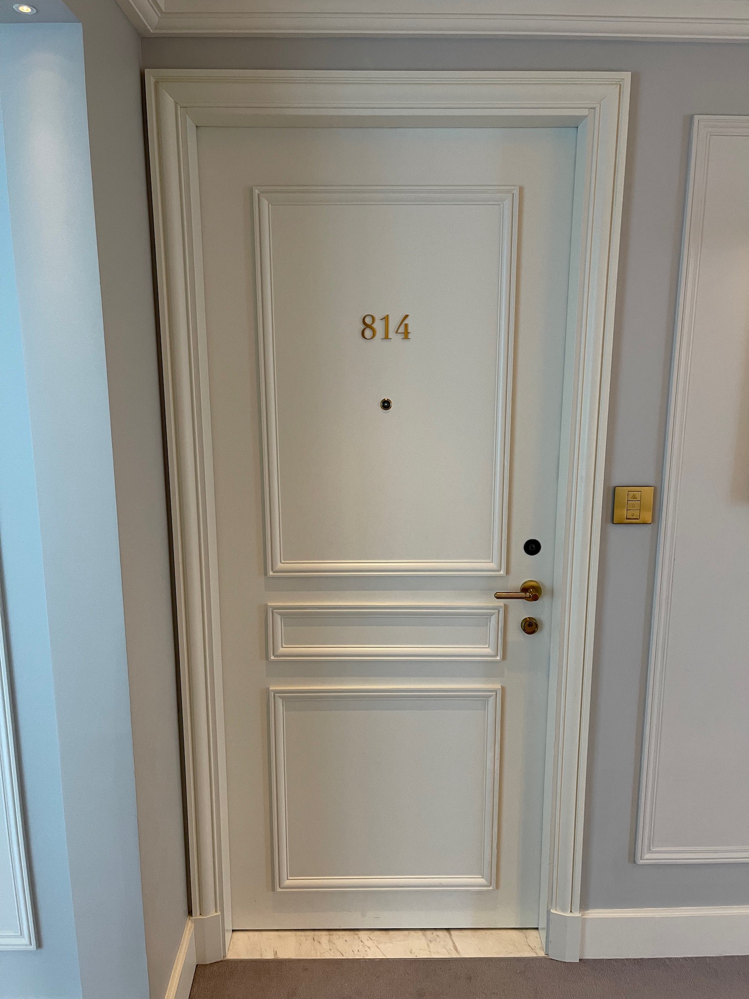 a white door with gold numbers