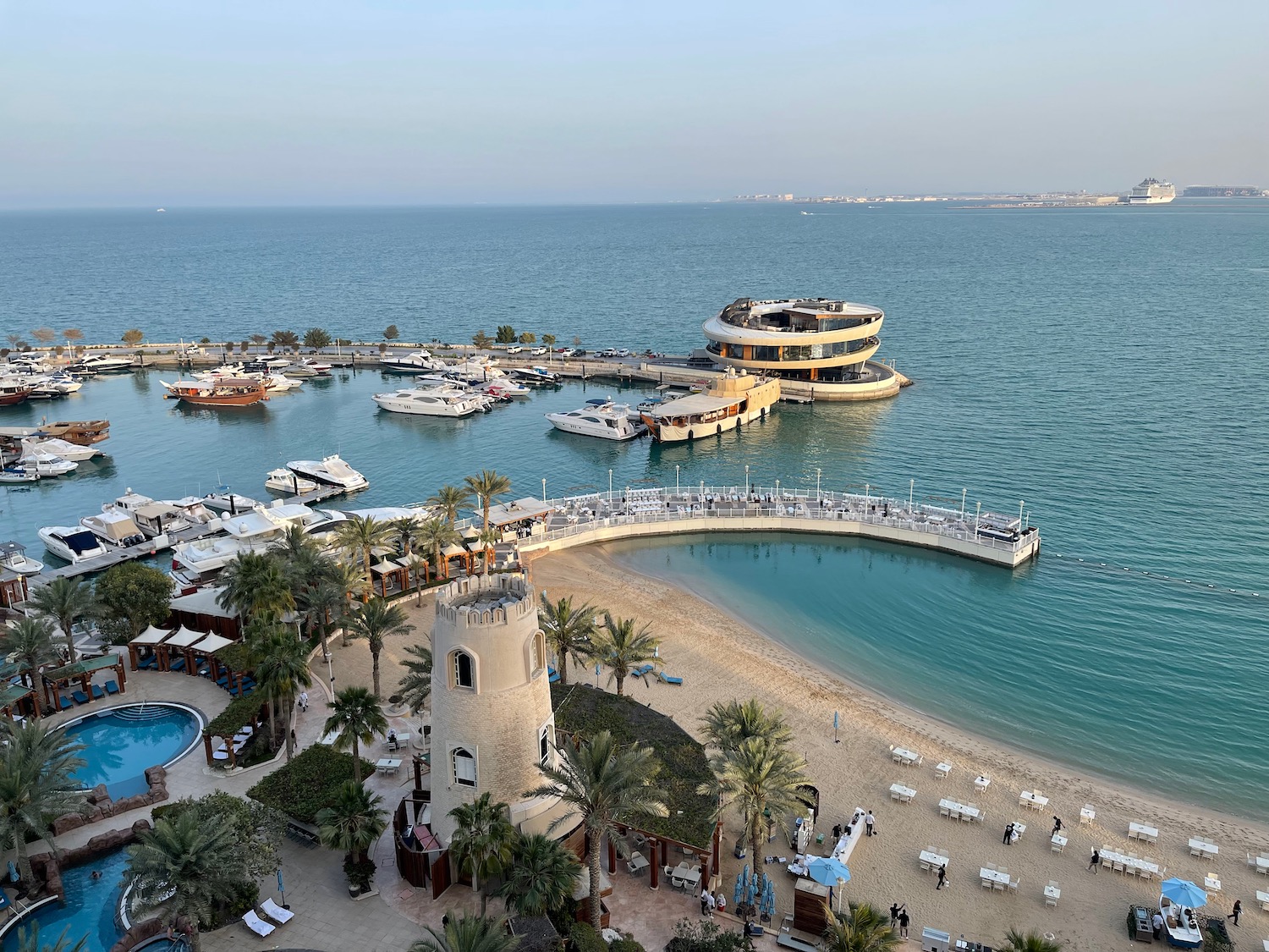 a beach with boats and a dock