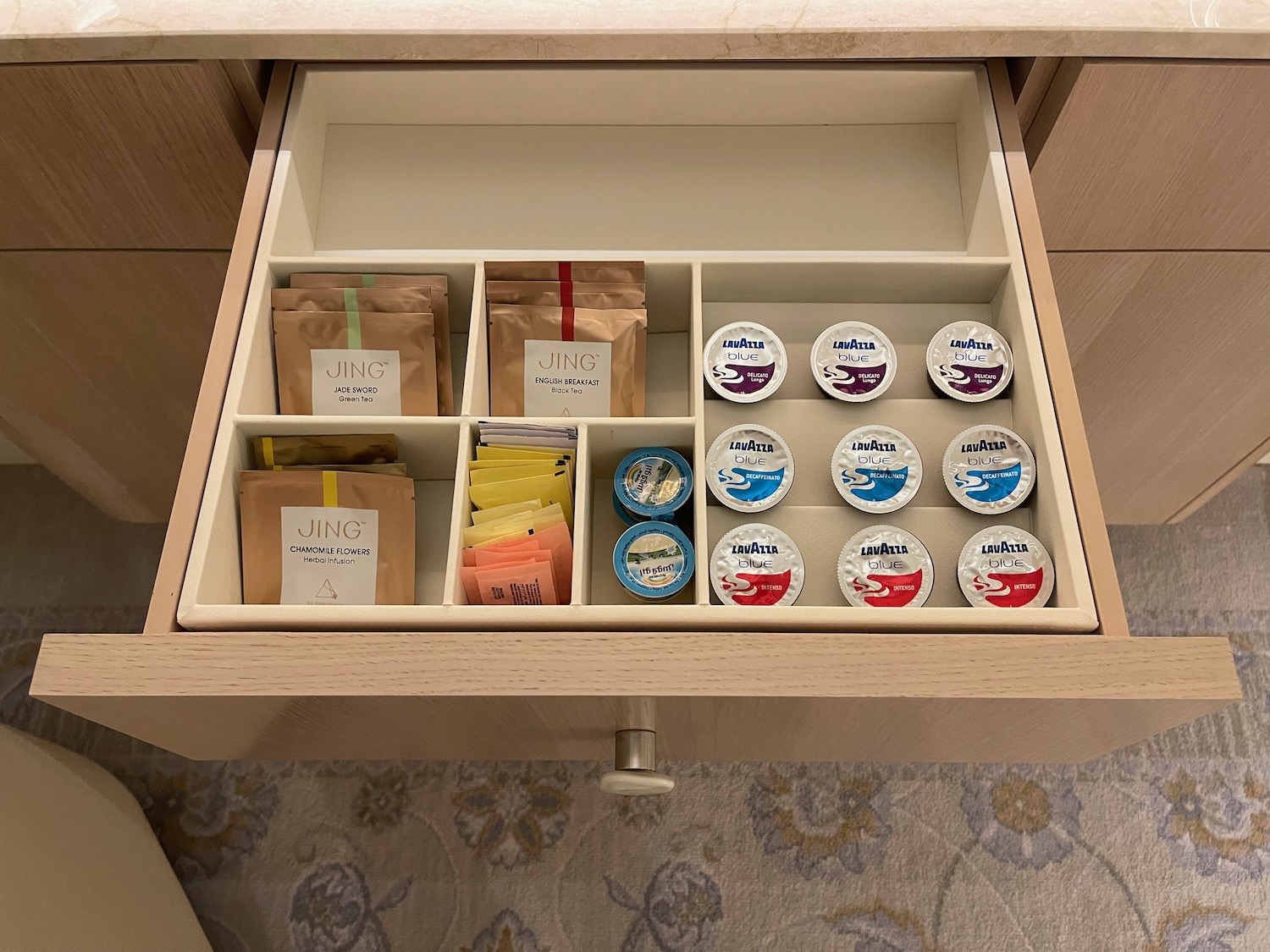 a drawer with a variety of condiments in it