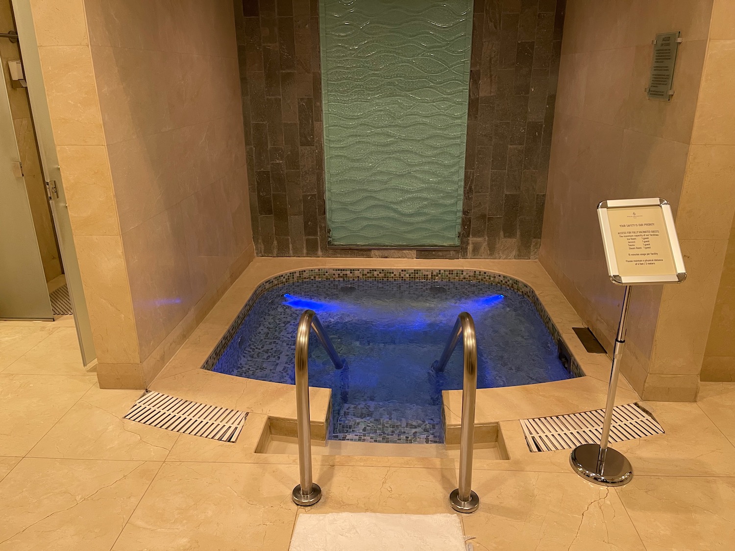 a hot tub with a metal railing