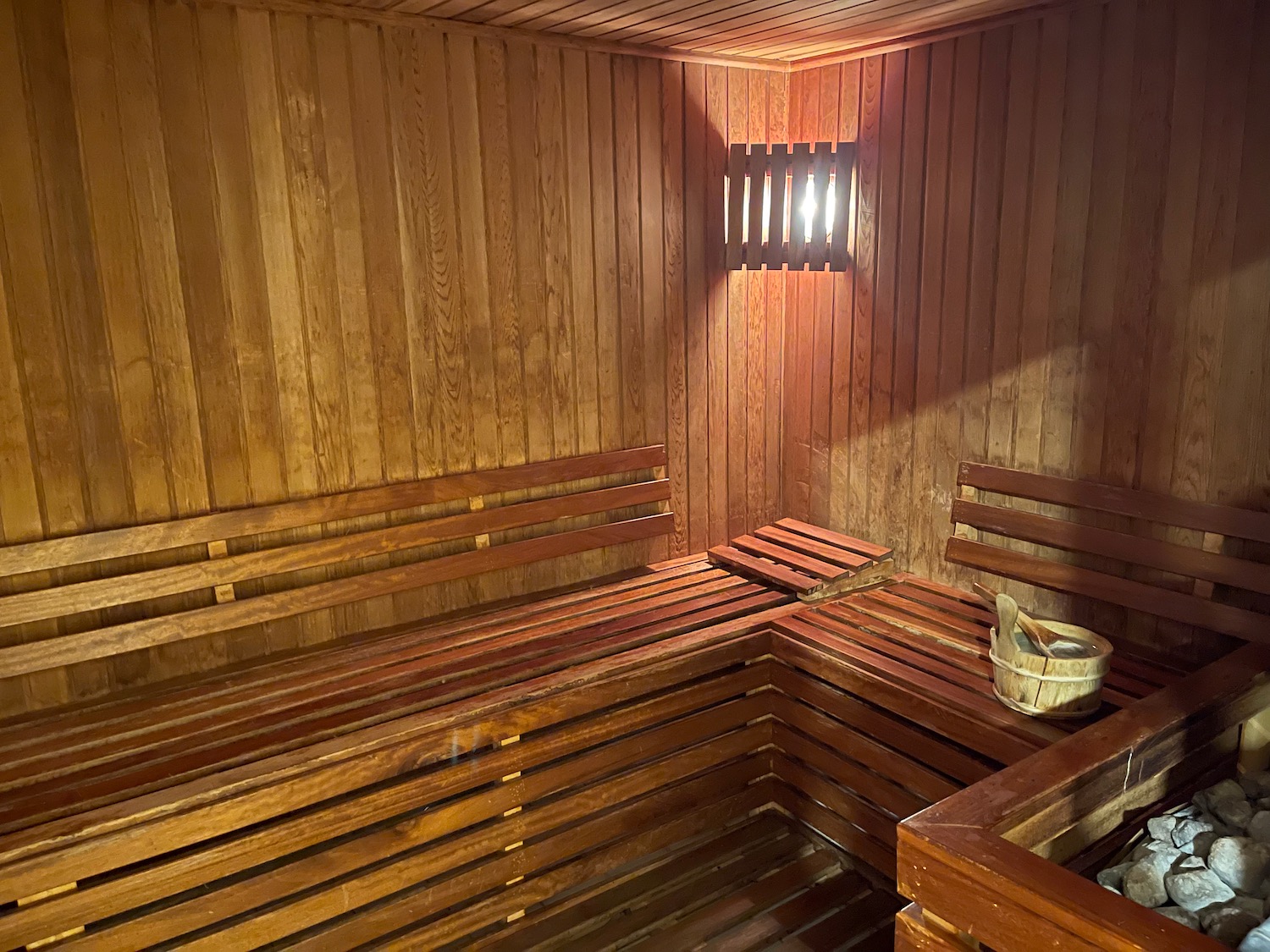 a wooden sauna with a bucket and a bucket