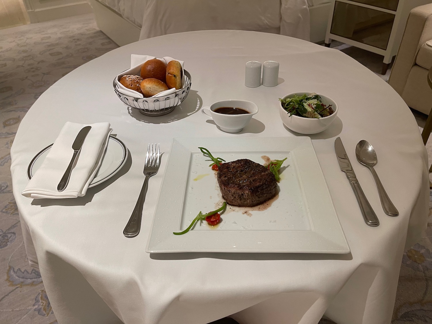 a plate of steak and salad on a table
