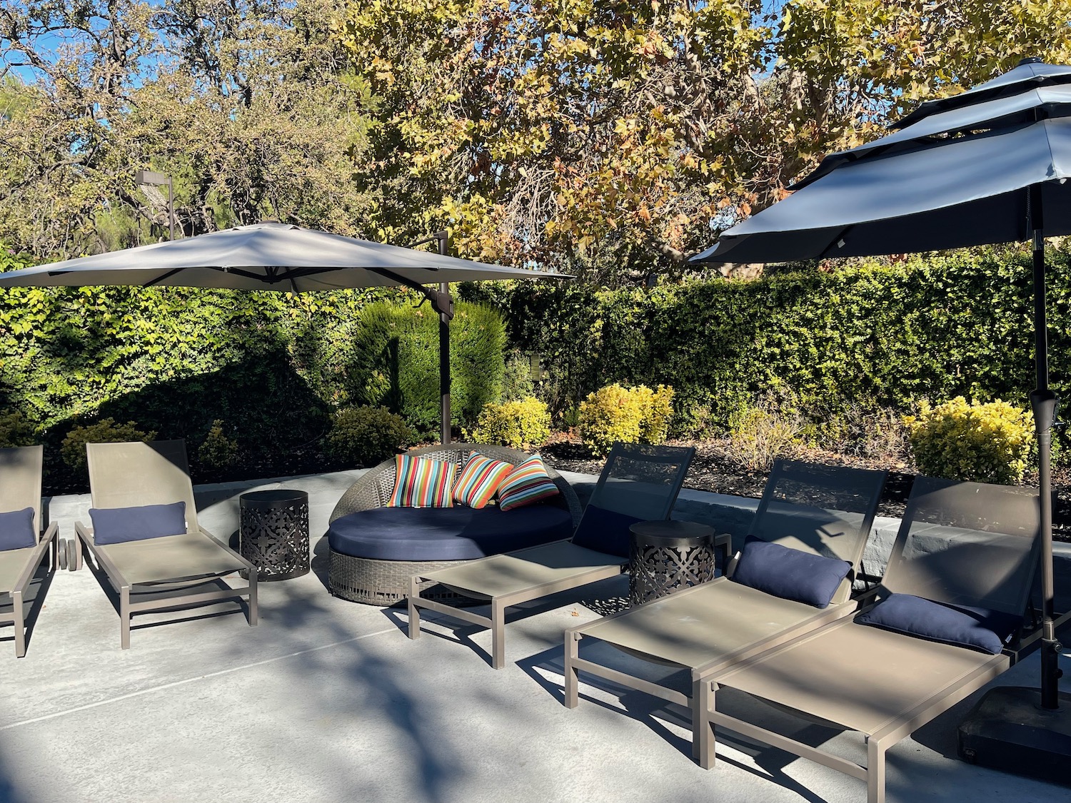 a group of chairs and umbrellas on a patio