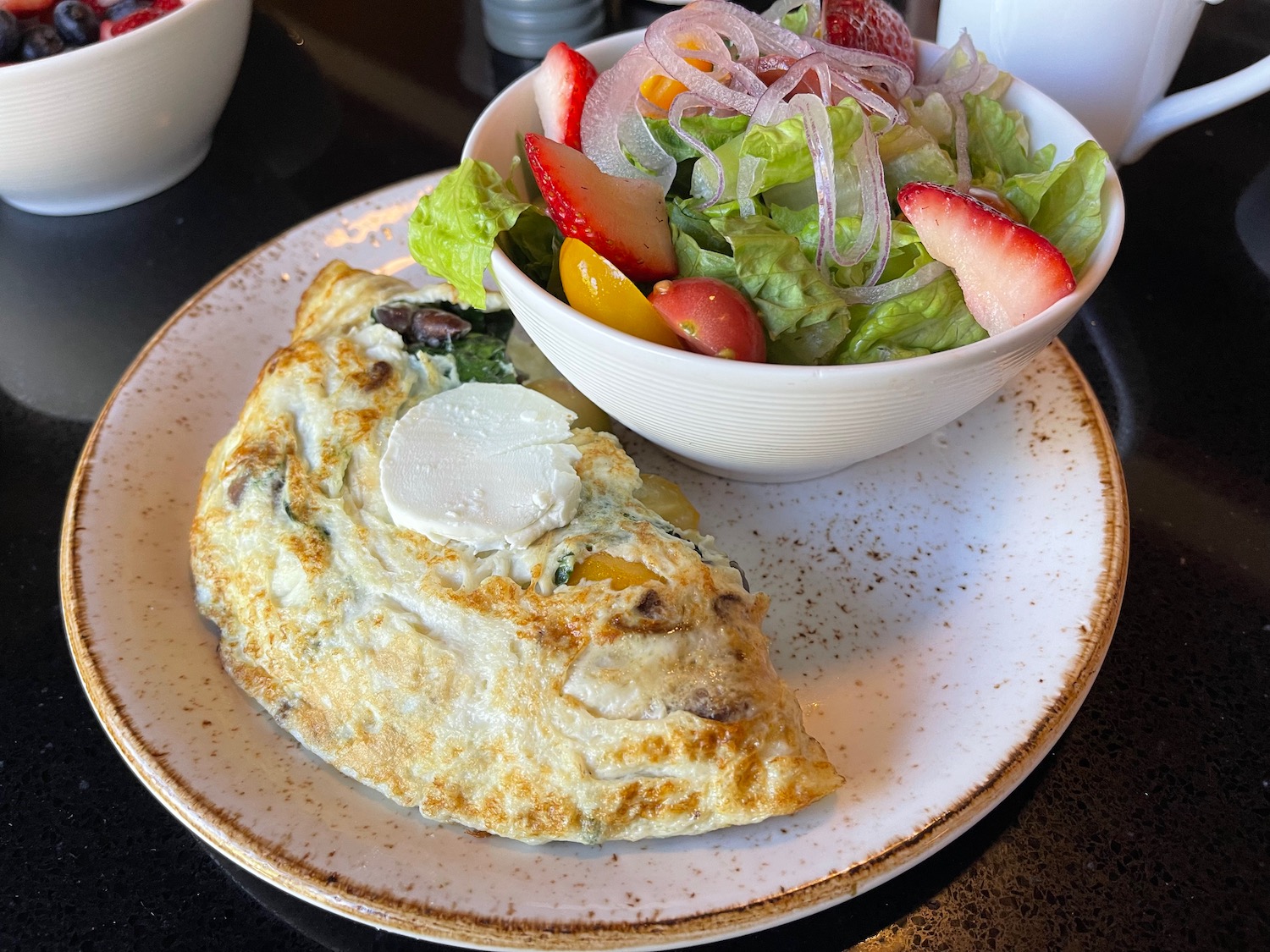 a plate of food with a bowl of salad