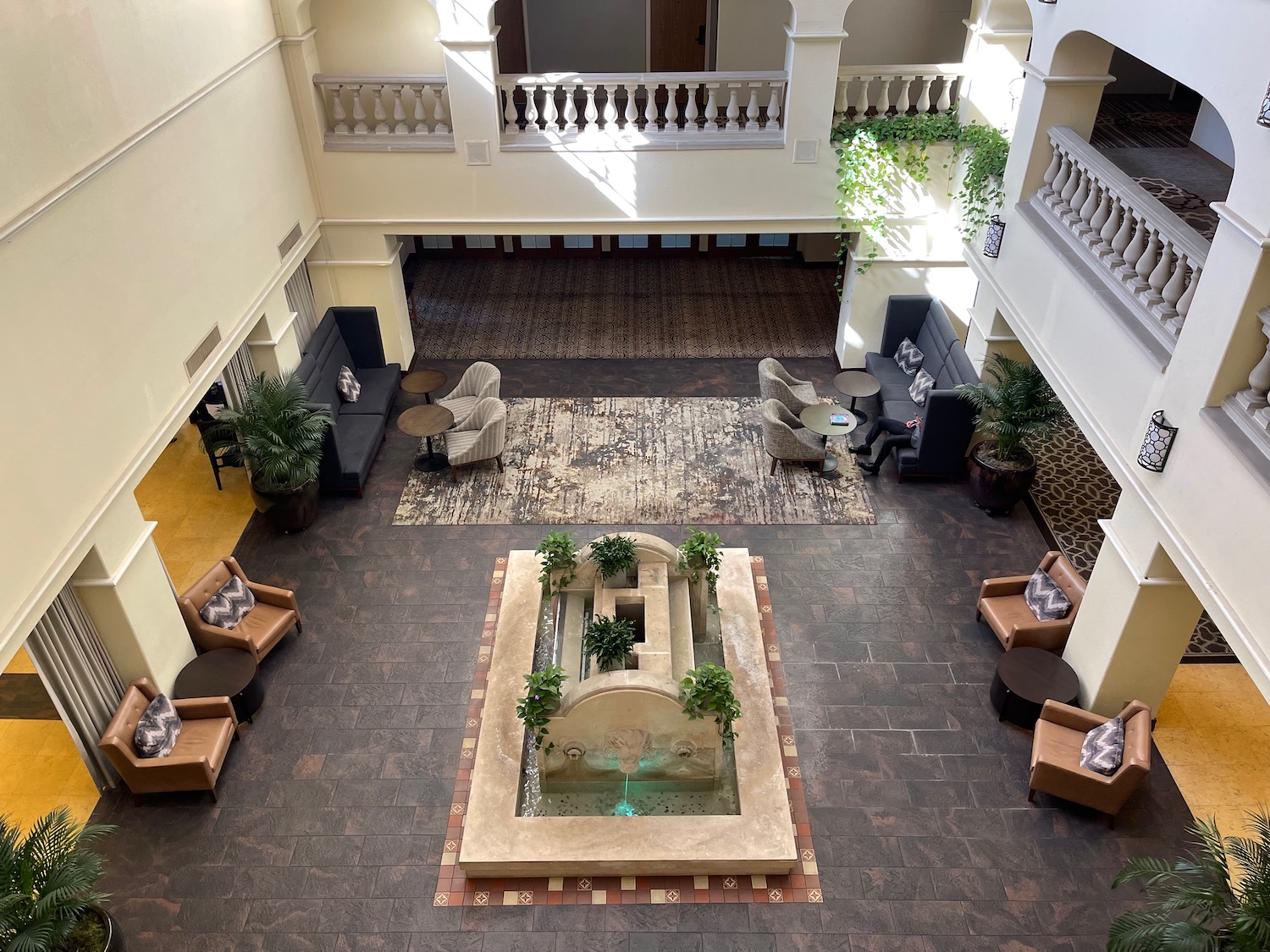 a room with a fountain and chairs