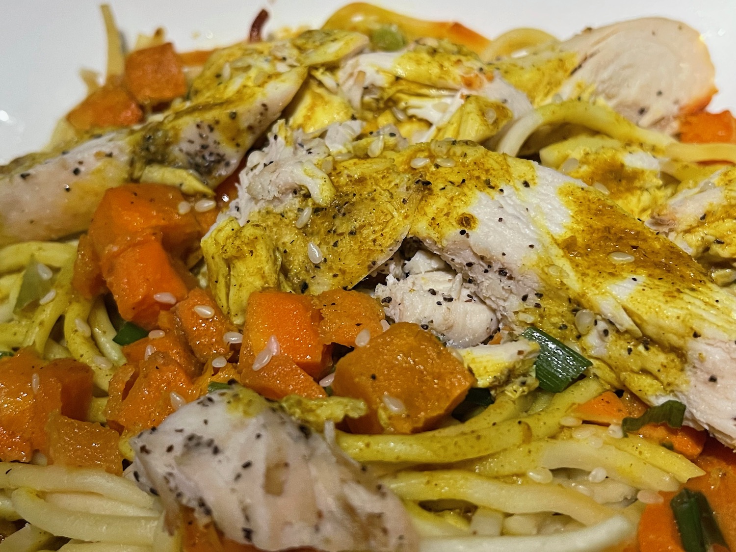 a plate of food with chicken and noodles