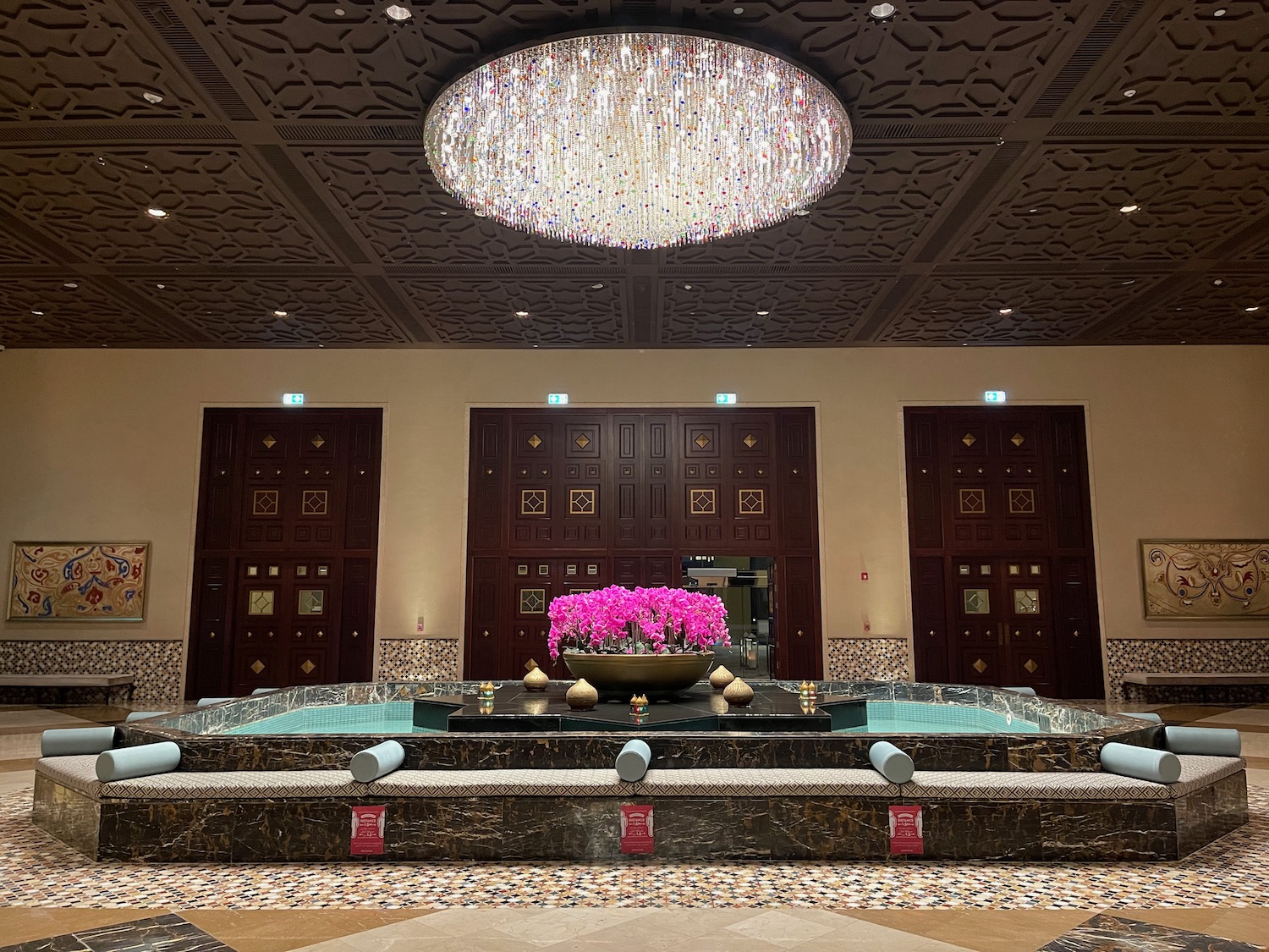 a large chandelier in a room with a large flower pot